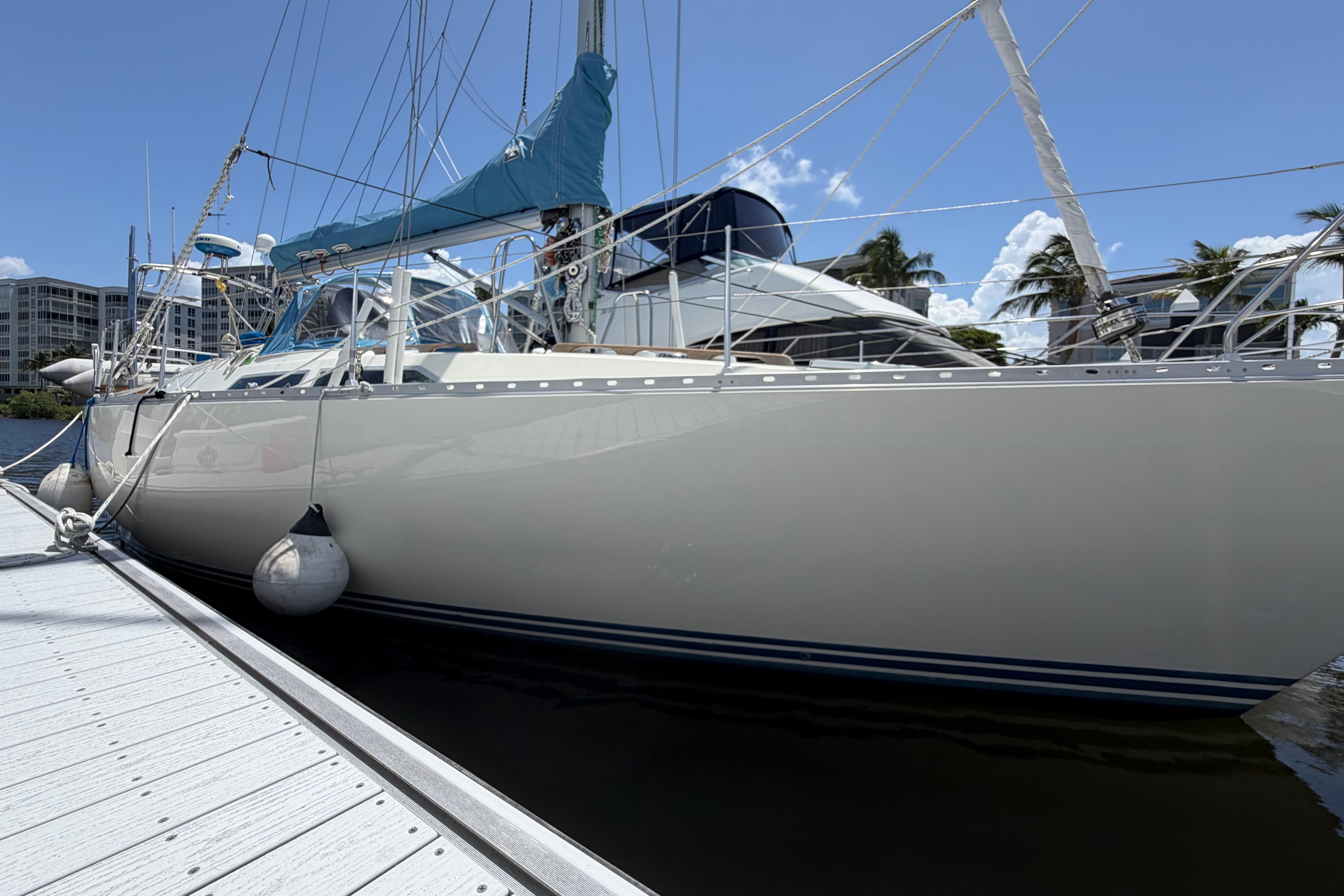 Sailboat Moody 376, 1987 model, docked under clear blue sky.