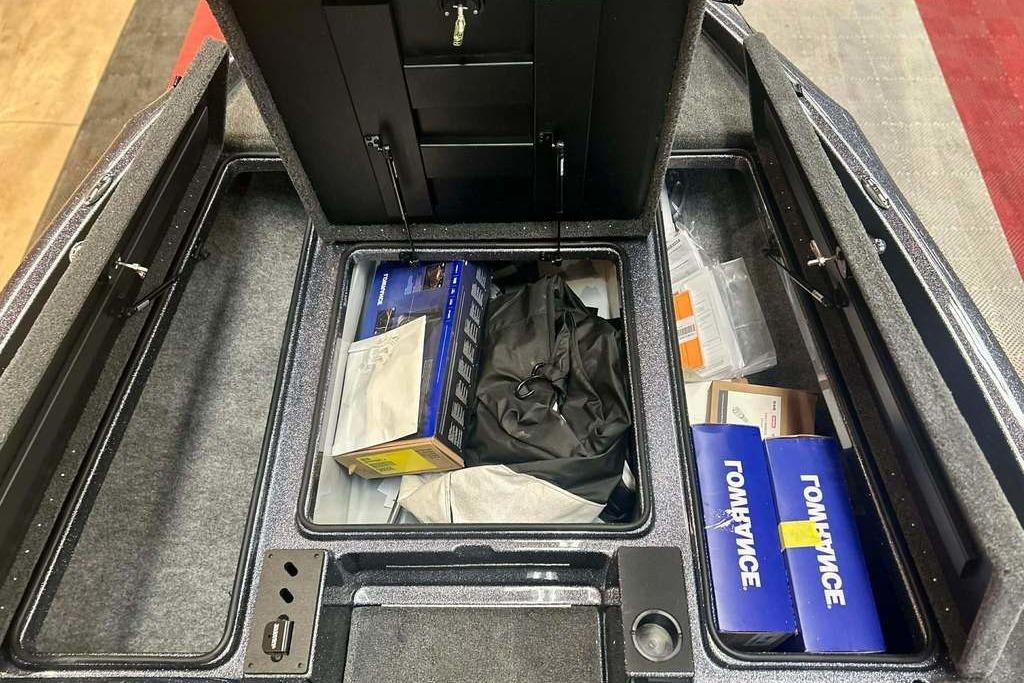 Interior storage compartments of a 2026 Triton 18 TrX boat, featuring organized equipment.