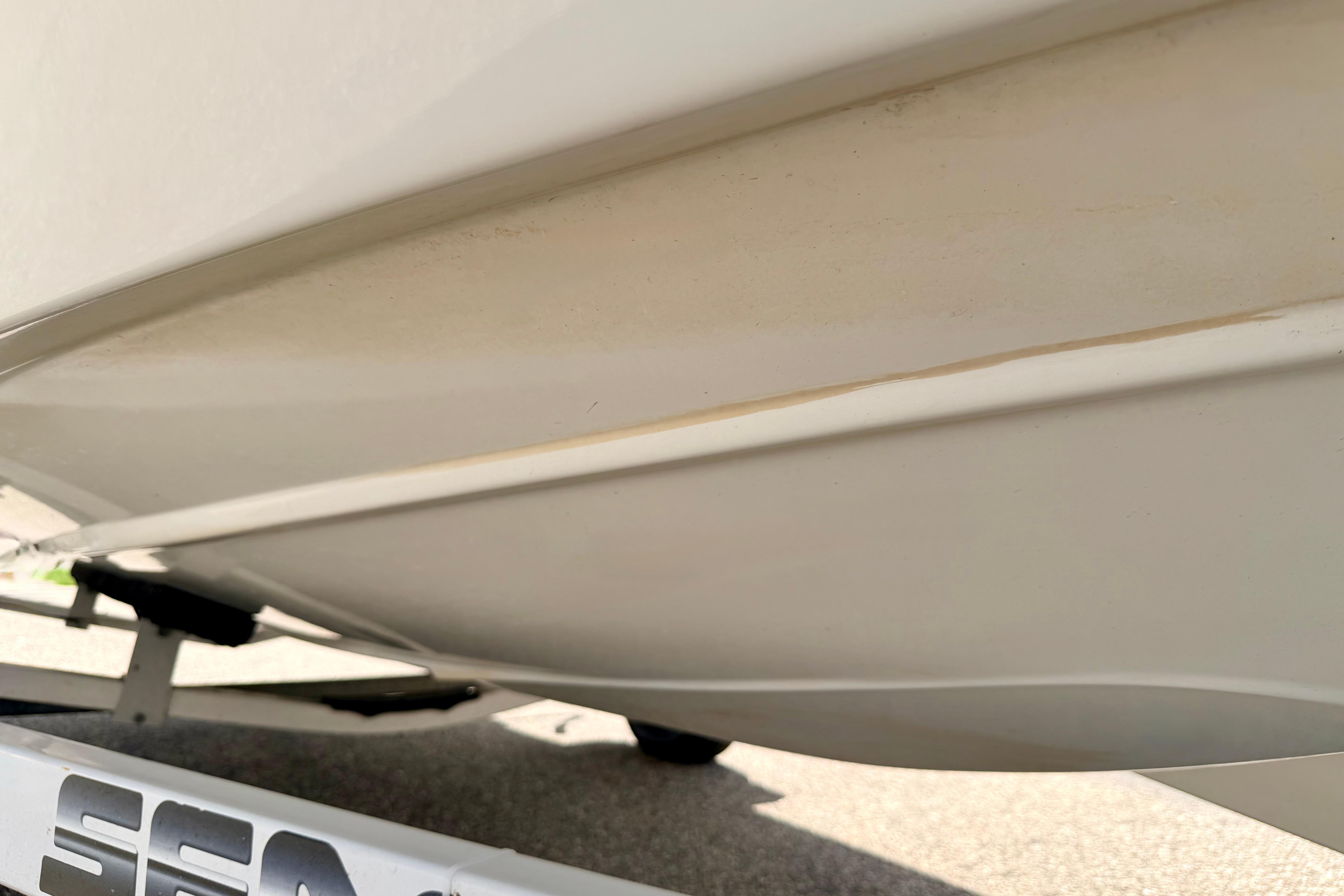 Close-up of 2004 Bombardier SEADOO Utopia 185 boat hull on trailer.