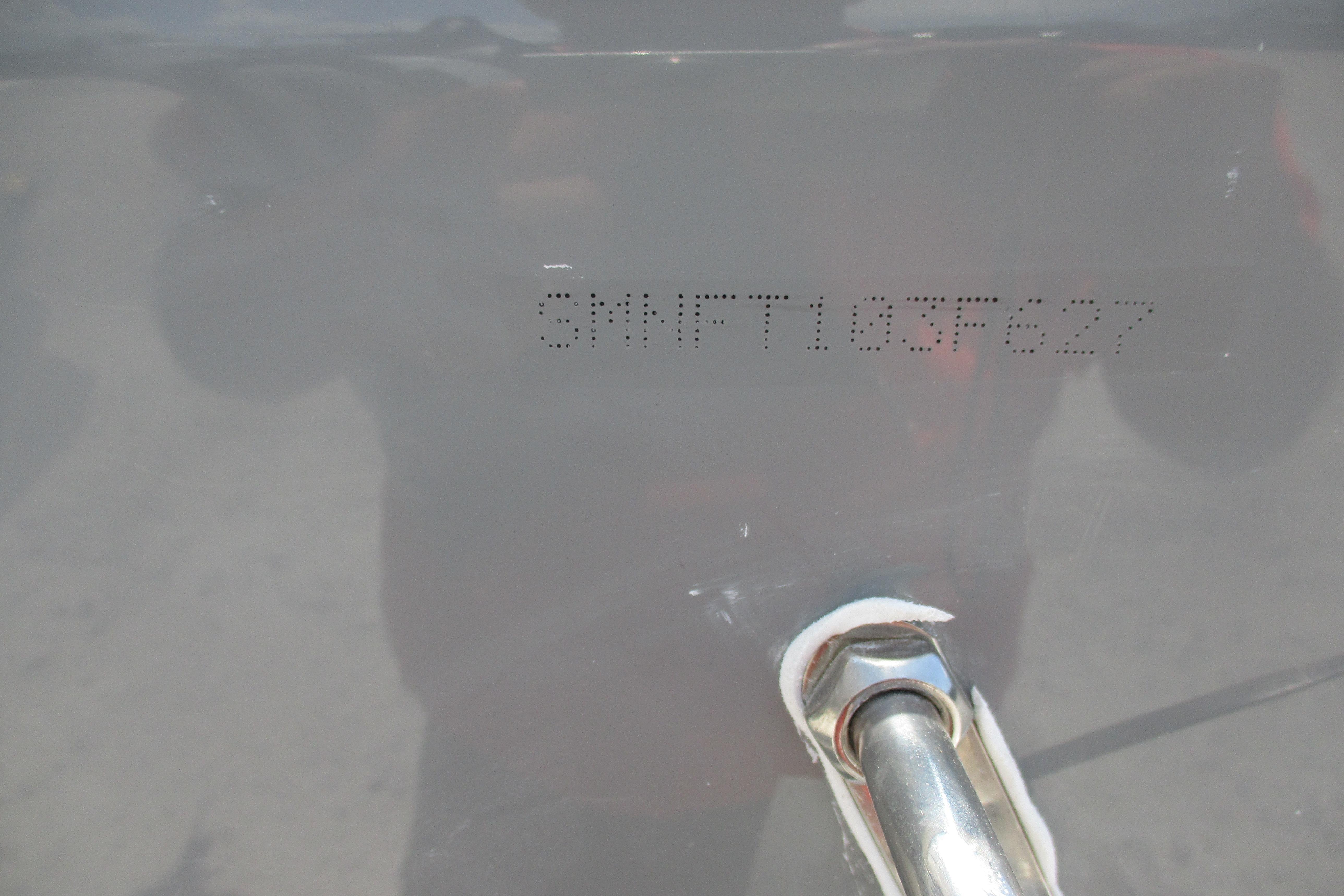 2027 Sportsman Open 252 Center Console hull identification number on gray surface.