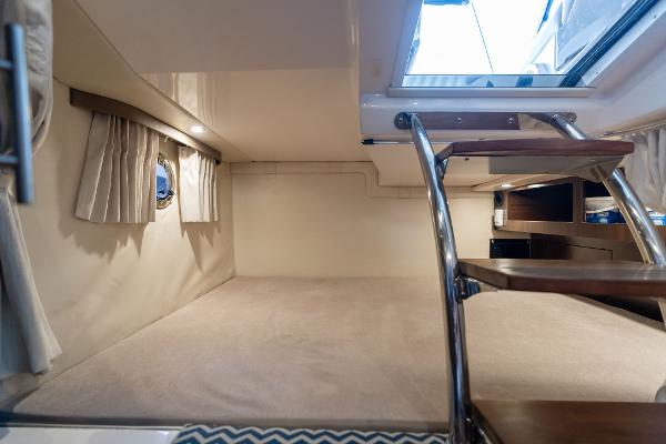 Interior cabin of 2016 Regal 28 Express boat with stairs and window.