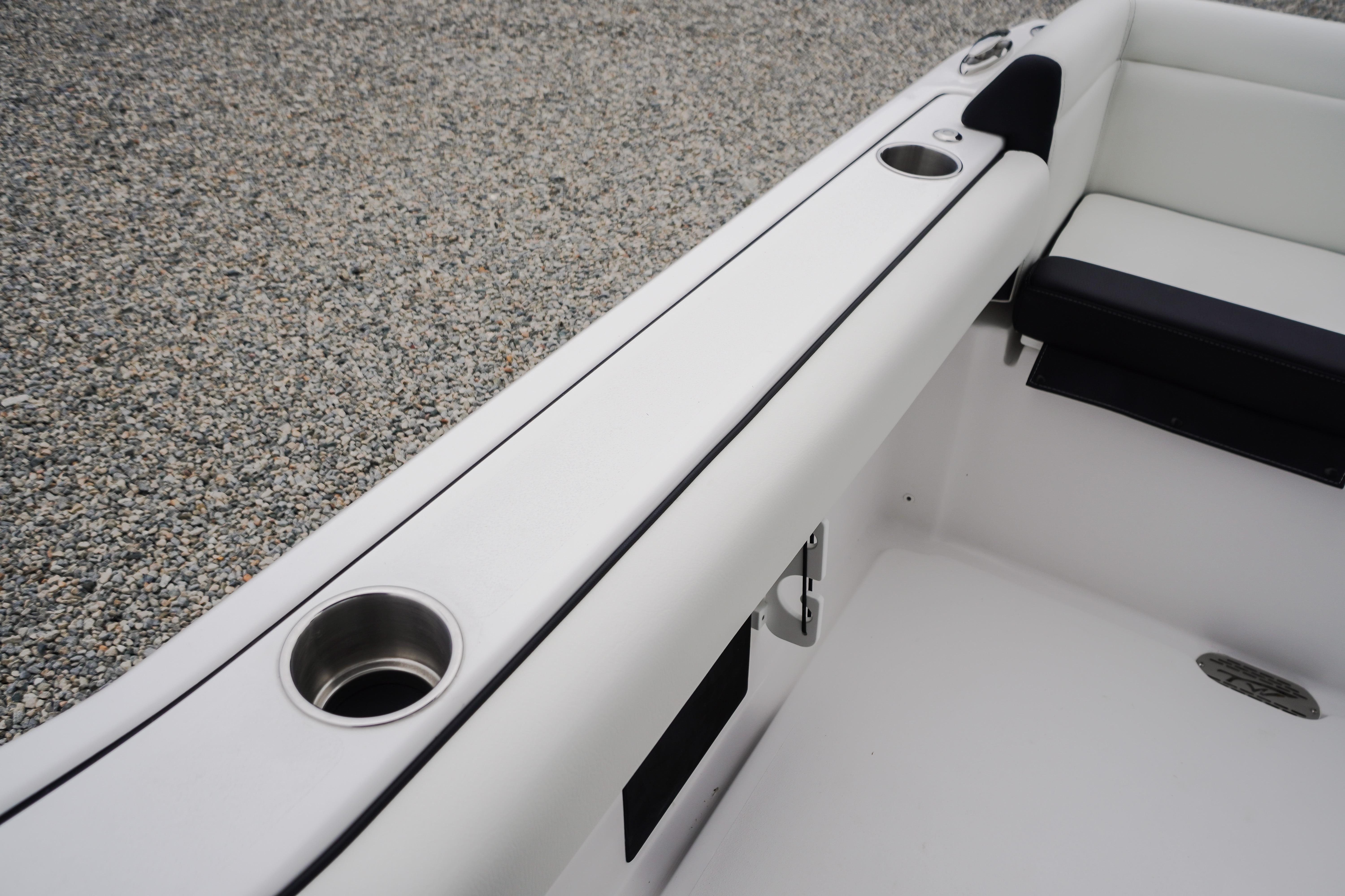 2026 Tidewater 232 SS boat interior with cup holders and white seating.