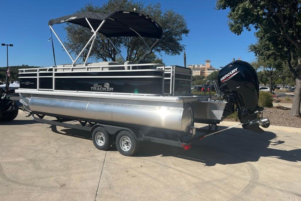 2026 Sun Tracker Fishin' Barge 22 DLX pontoon boat with Mercury outboard motor on trailer.