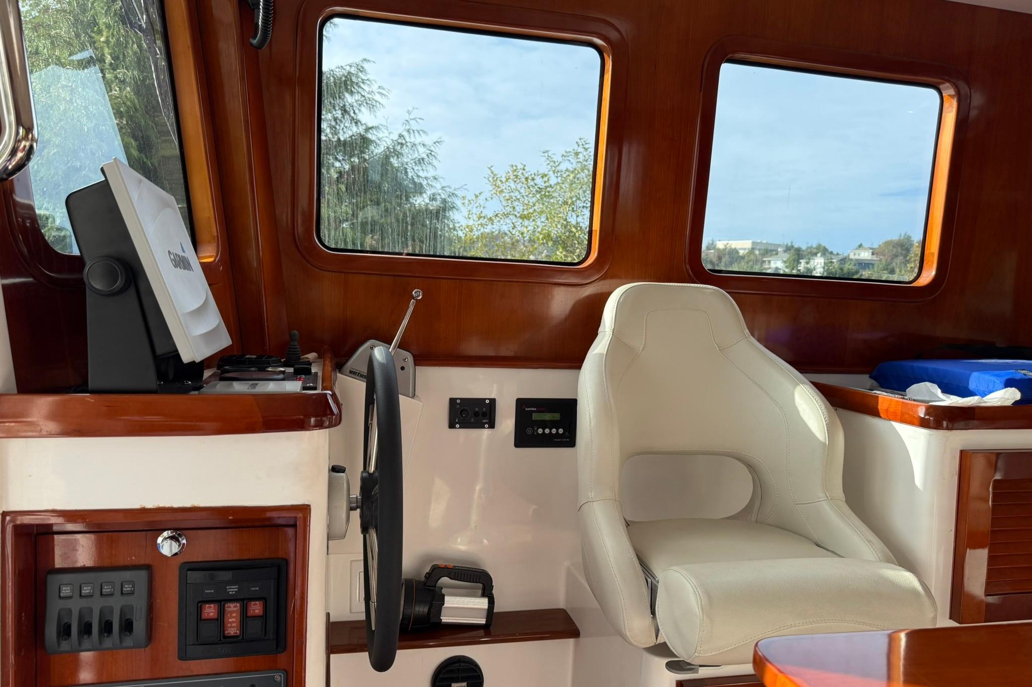 Interior of a 2020 SeaPiper 35 boat, featuring a steering wheel and captain's chair.