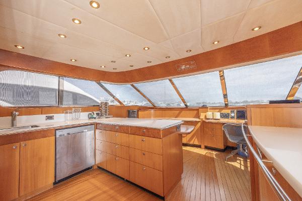 Luxurious kitchen interior of 2001 Grand Harbour 76 yacht with modern appliances and panoramic windows.