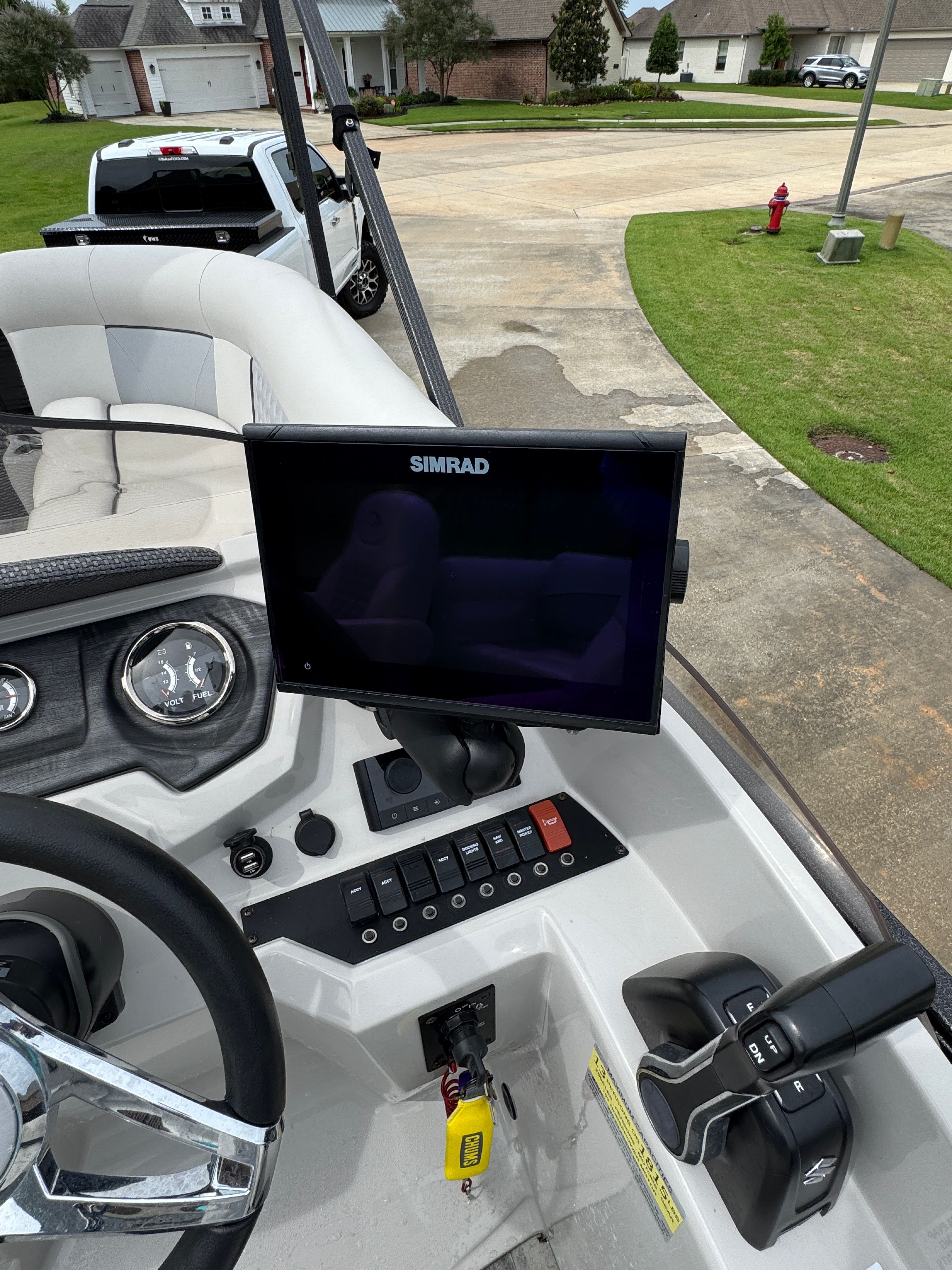 Interior view of a 2022 Crest Classic DLX 220 boat with Simrad display.