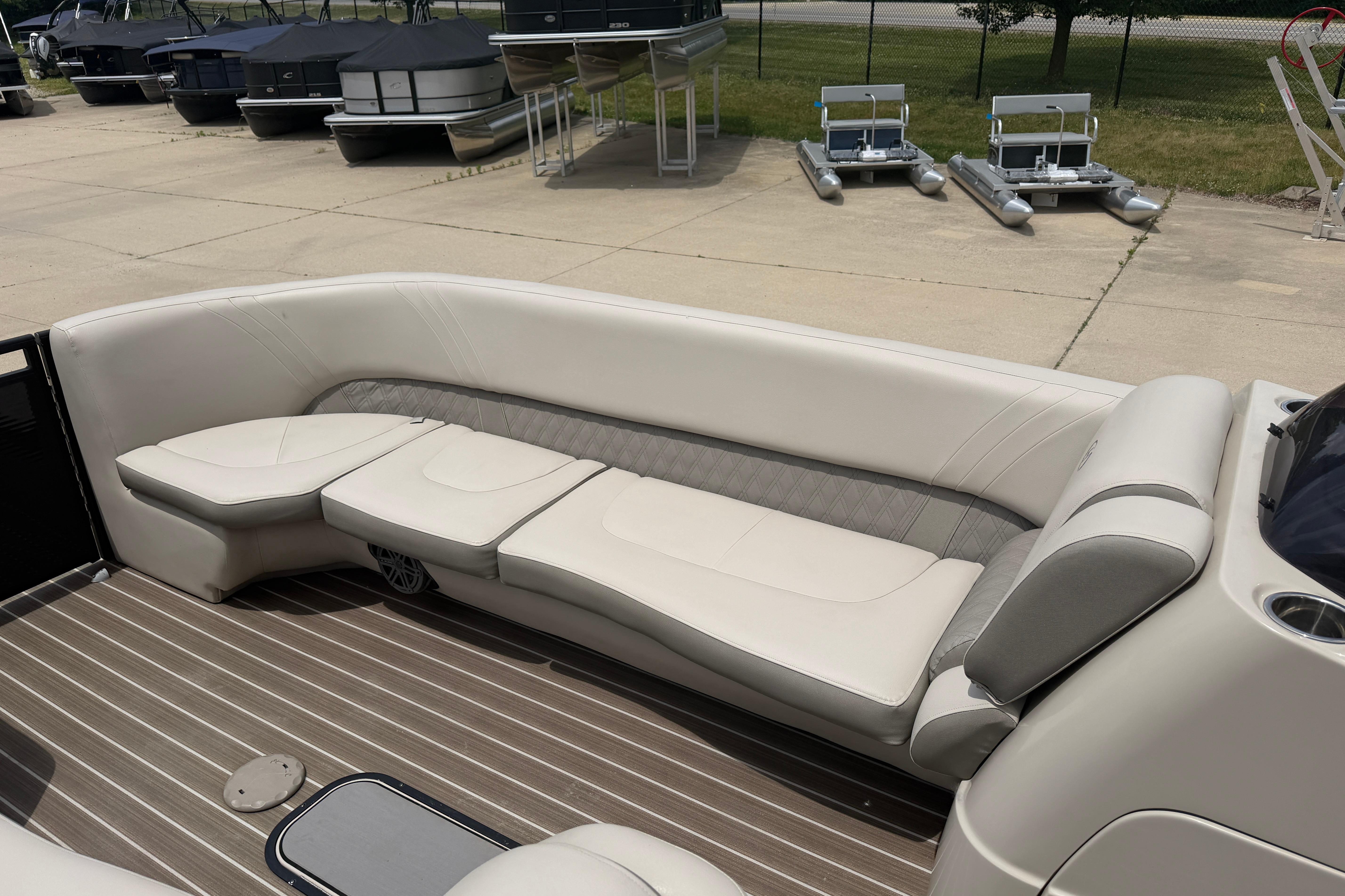 2019 Harris Solstice 240 pontoon boat interior with beige seating and wood-patterned flooring.