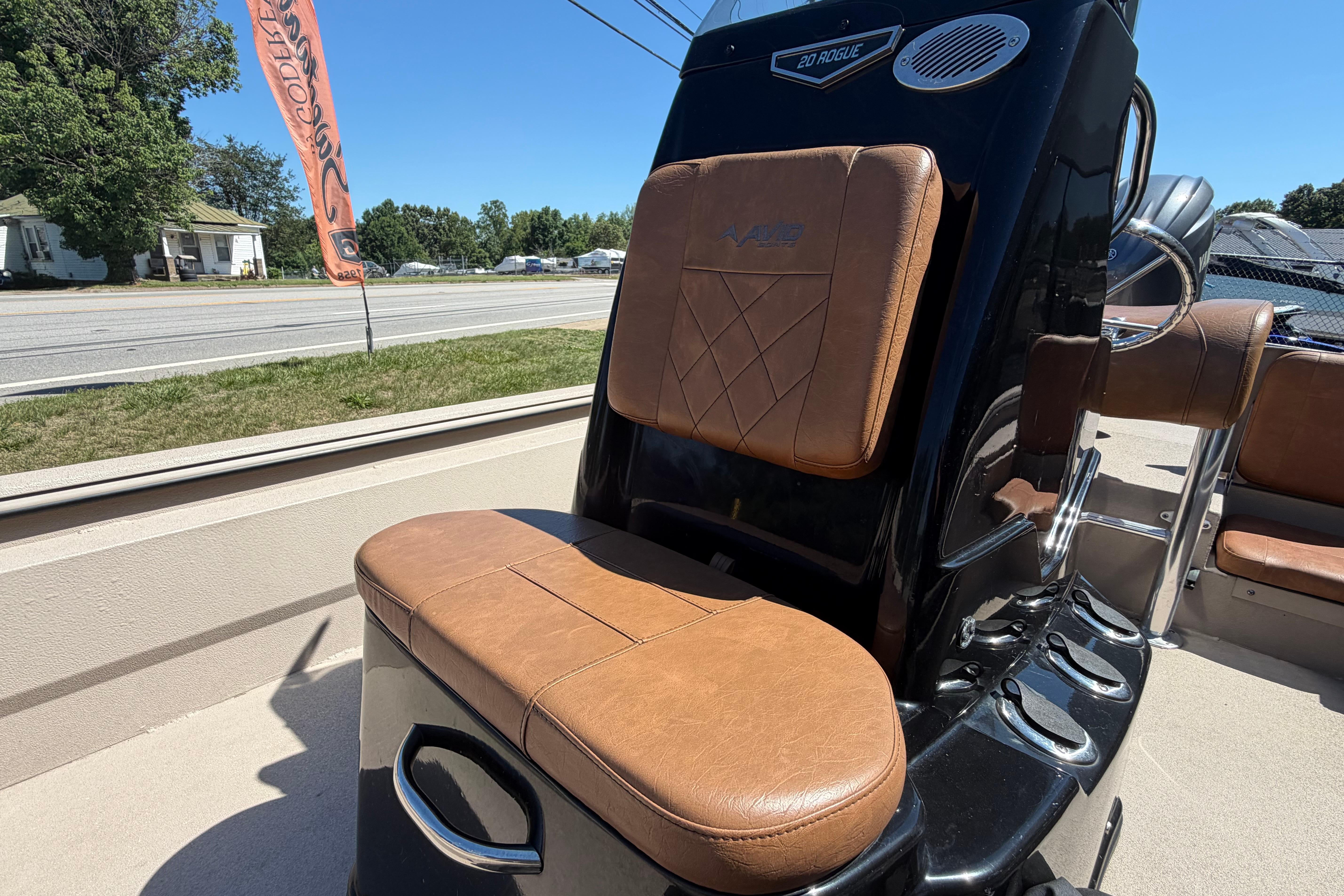 2024 Avid 20 Rogue CC boat with brown leather seating and sleek black console.