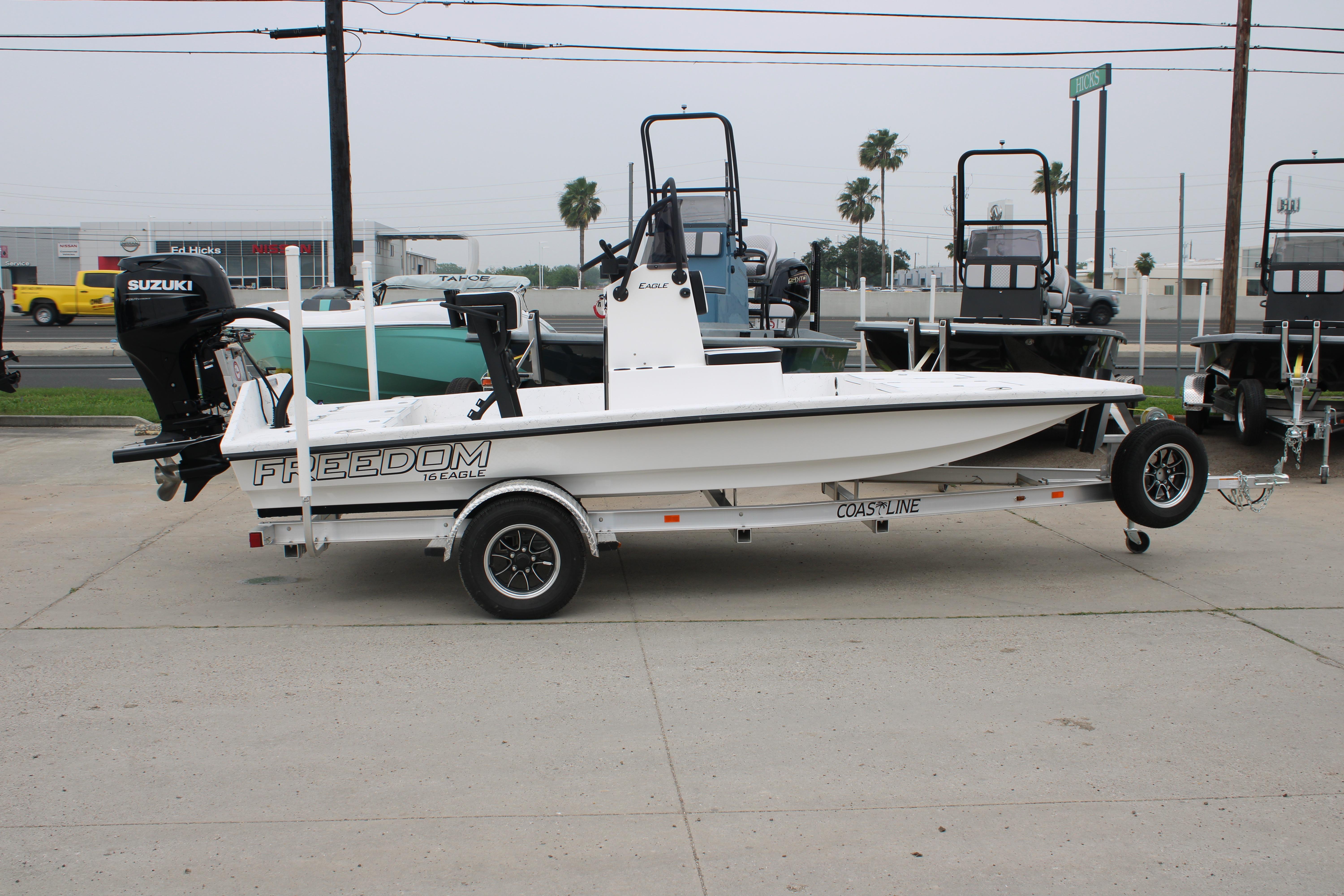 2026 Freedom Boats 16' Eagle on trailer, featuring Suzuki outboard motor, parked outdoors.