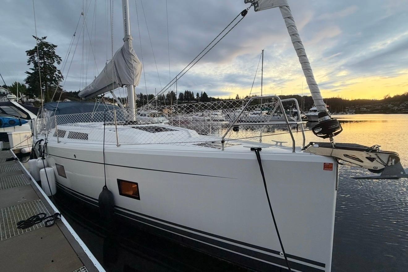 2022 Hanse 418 sailboat docked at sunset, showcasing sleek design and modern features.