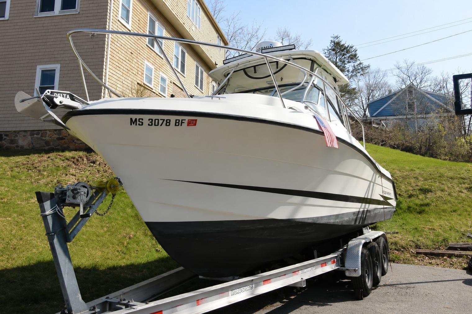 2003 Hydra-Sports Vector 2800 WA boat on trailer, parked near residential area.