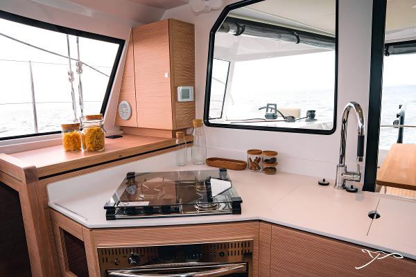 Modern kitchen interior of 2025 Nautitech 40 Open catamaran with sleek design and ocean view.