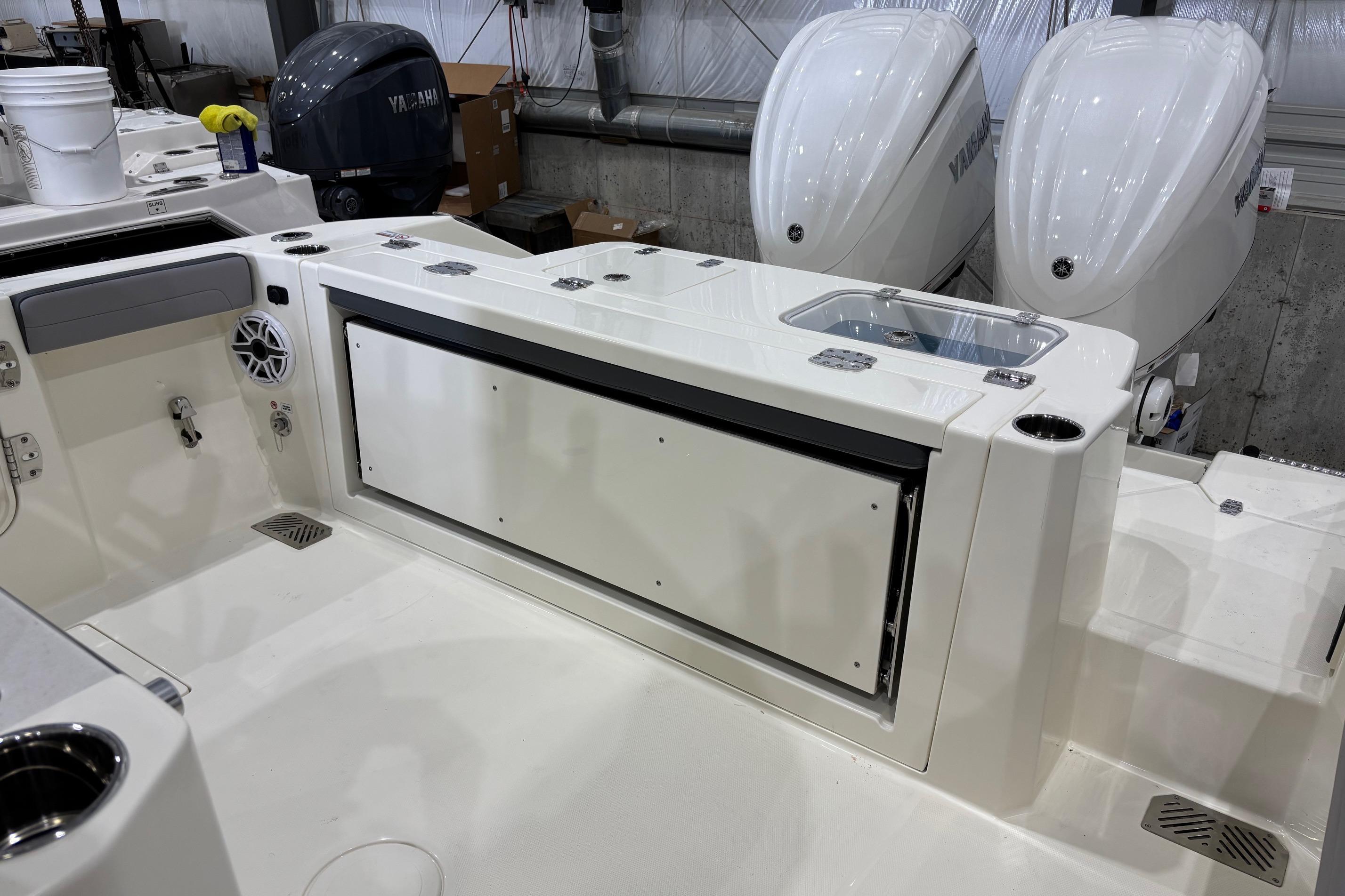 2026 Cobia 285 Open Center Console boat interior with dual Yamaha engines.