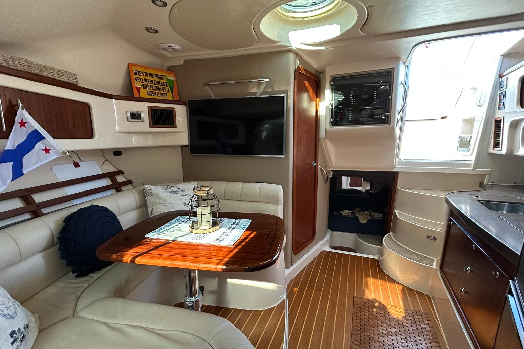Luxurious interior of a 2007 Grady-White Express 360 boat with seating, table, and modern amenities.
