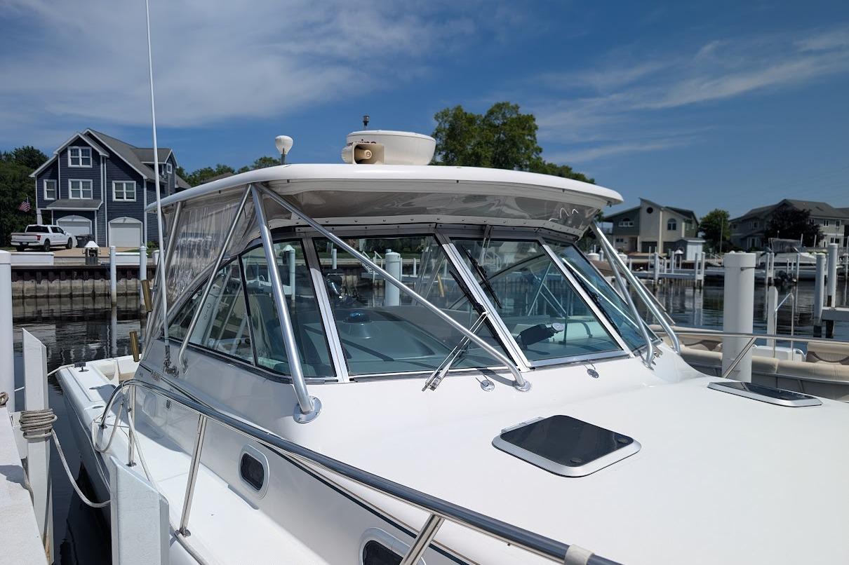 2000 Pursuit 3400 Express boat docked at marina, featuring sleek design and spacious cabin.