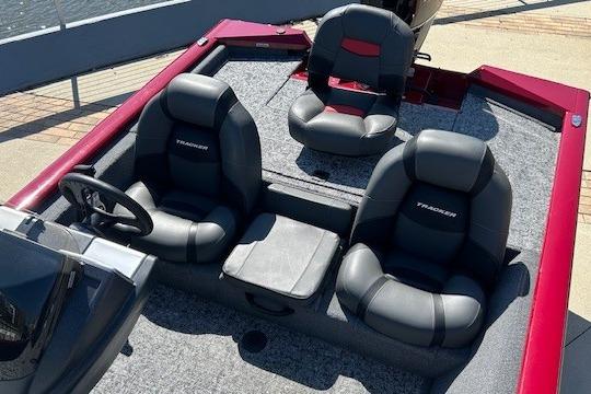 2026 Tracker Pro Team 175 boat interior with three black seats and steering wheel.