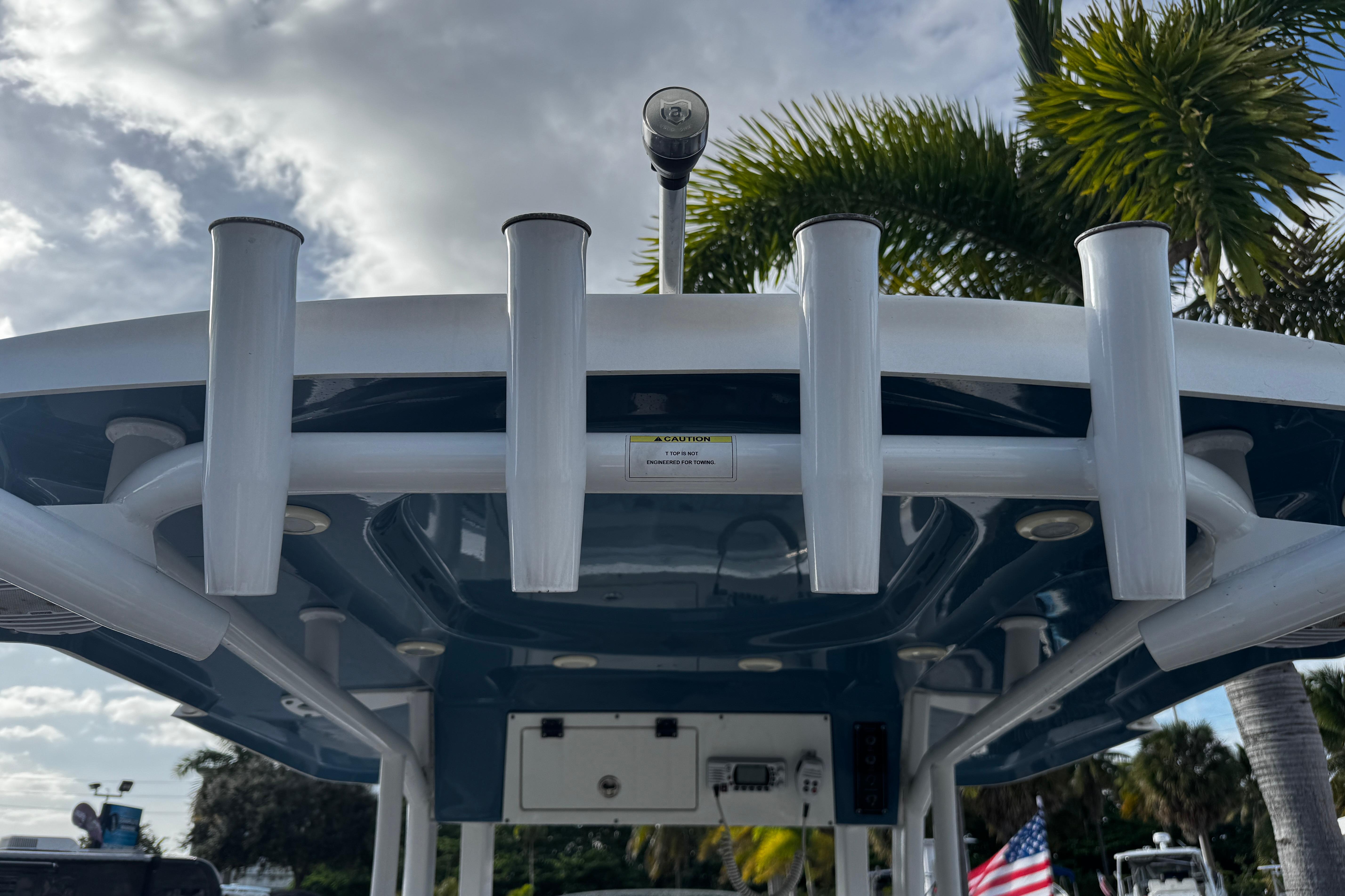 2022 Sea Pro 239 Center Console boat with rod holders and canopy, under a cloudy sky.