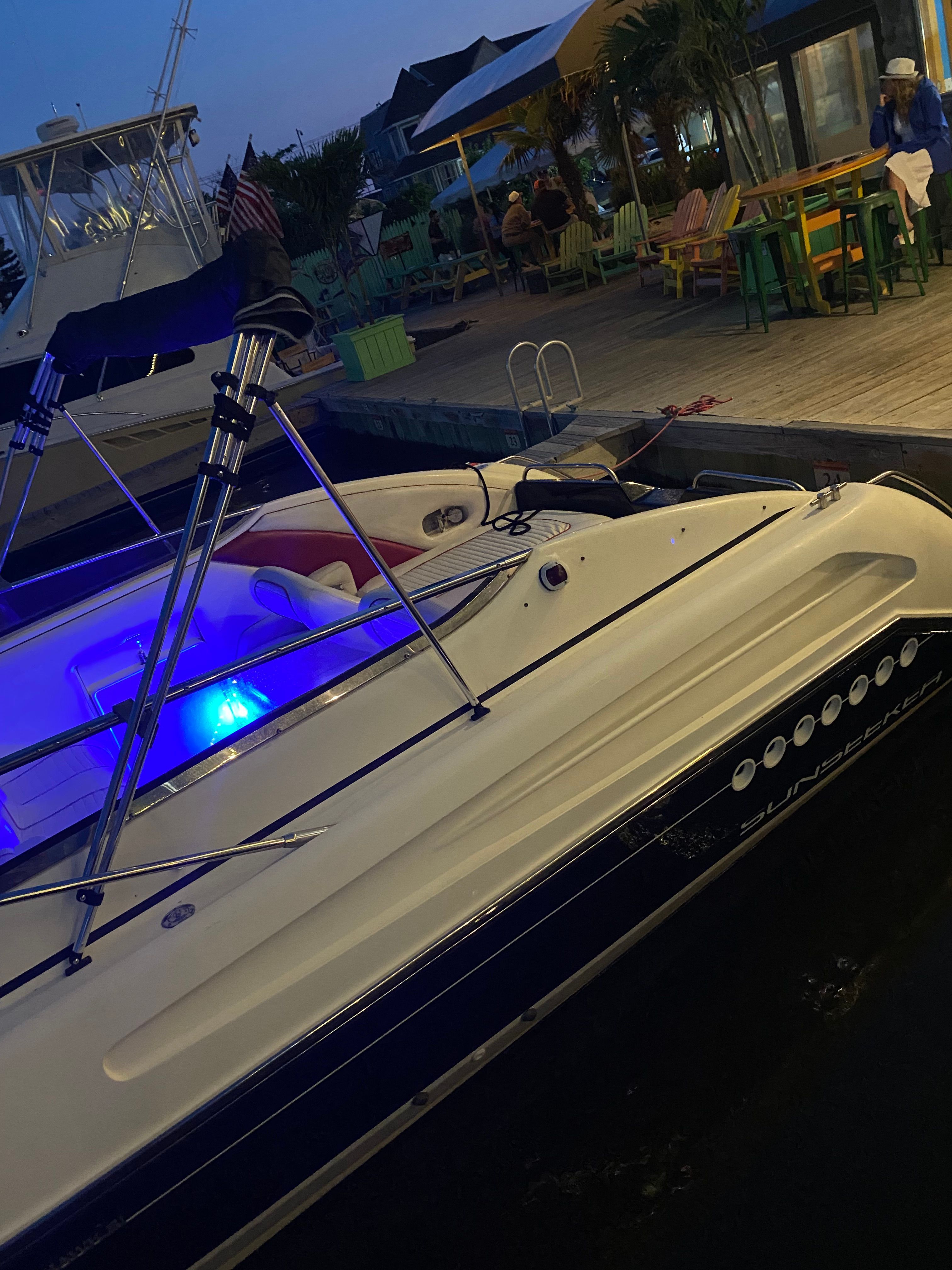 Sunseeker Hawk 31 boat docked with night lighting.