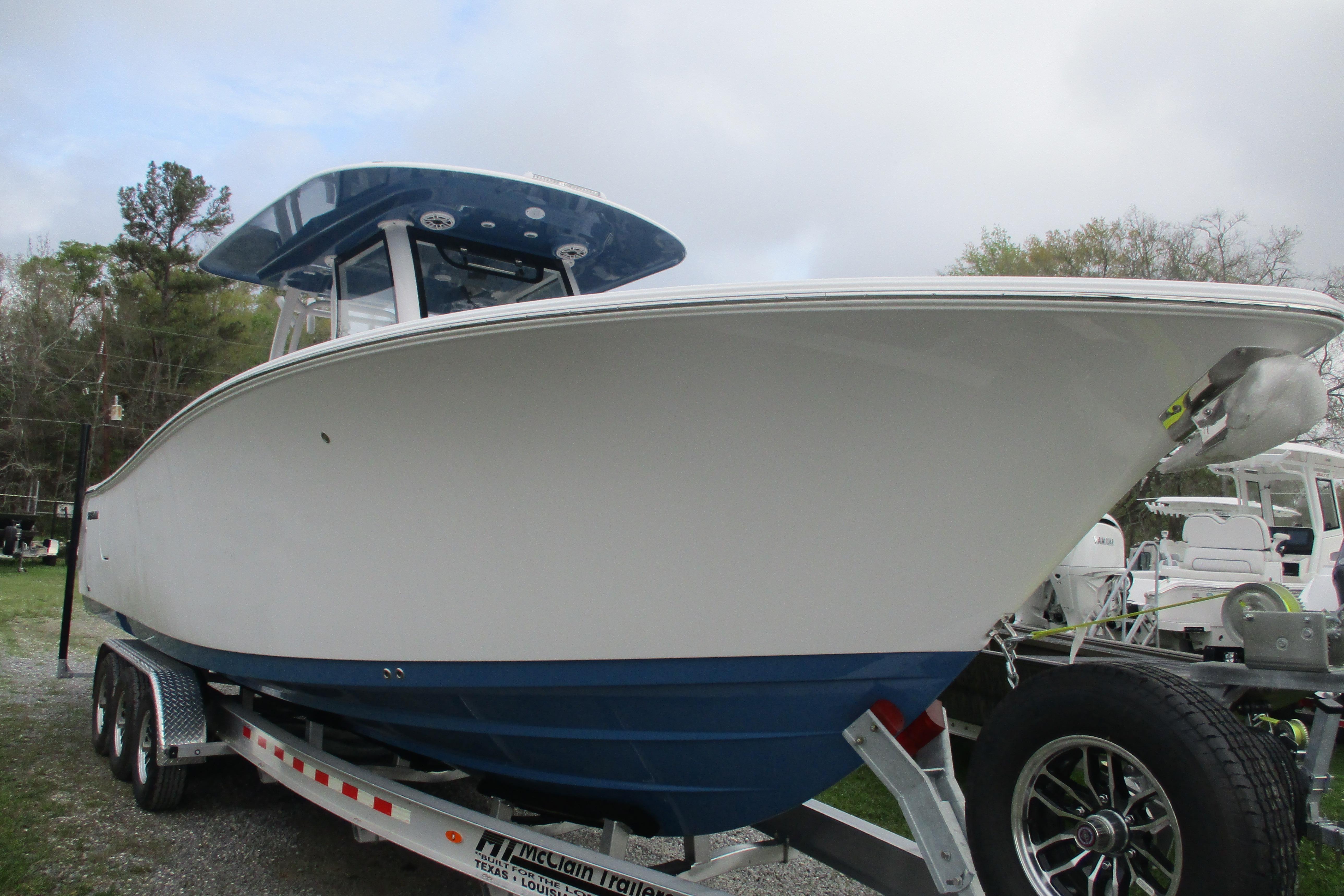 2026 Sportsman Open 302 Center Console boat on trailer, side view.