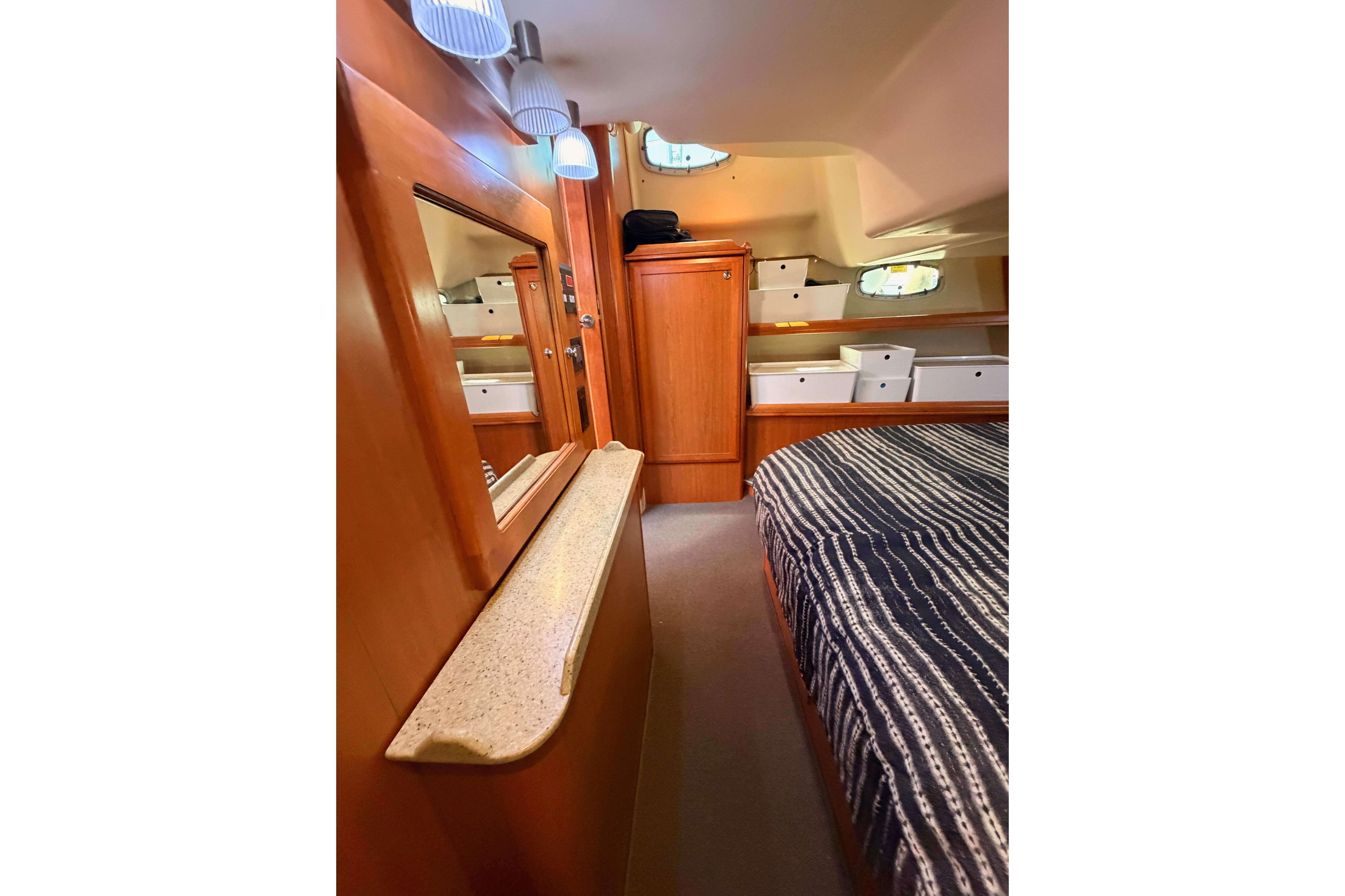 Interior of 2008 Hunter 45 Deck Salon yacht with wood finish and cozy sleeping area.