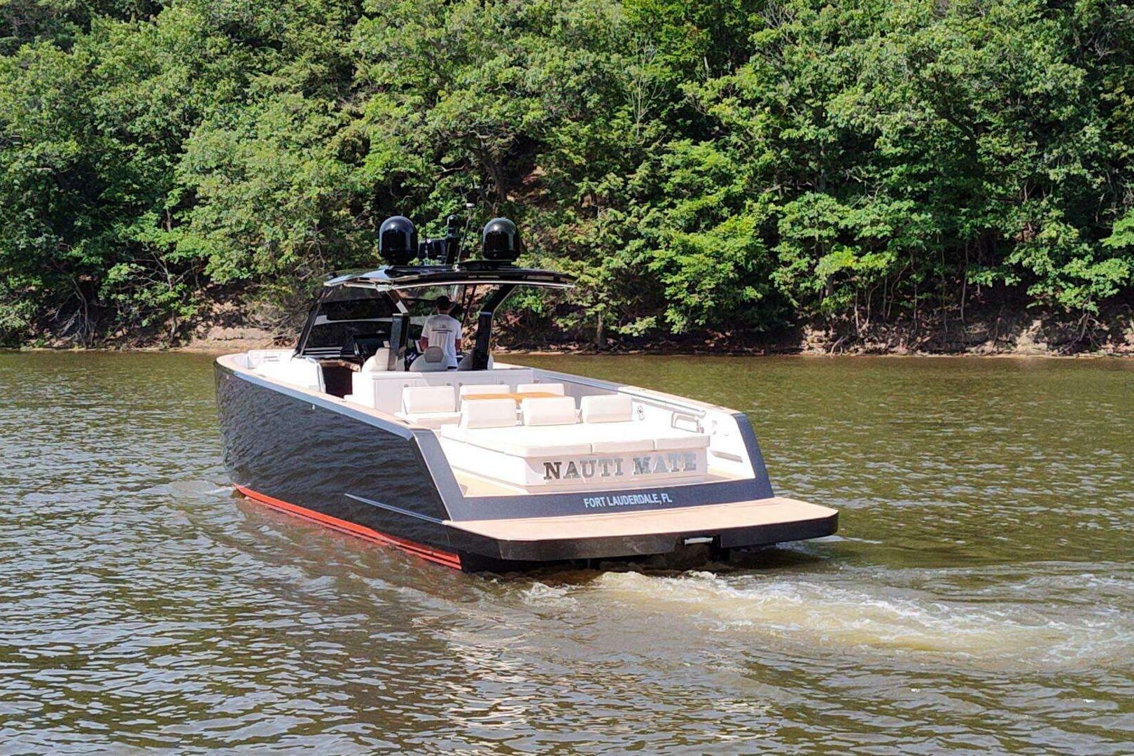 2023 Pardo Yachts P43 cruising on a scenic river with lush green trees.