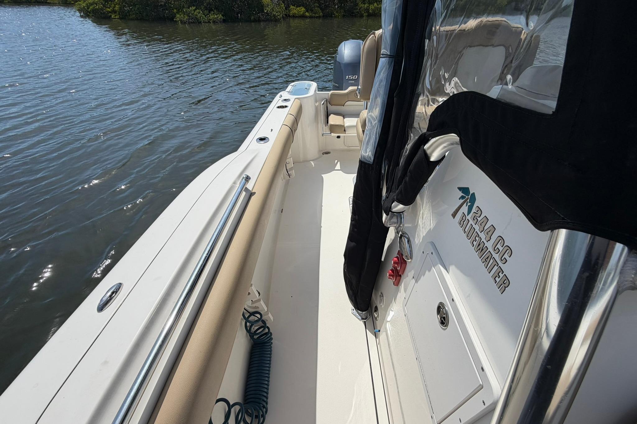 2019 Key West 244 Center Console boat on calm water, showcasing interior and branding.