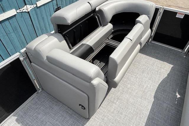 2026 Sun Tracker Party Barge 20 DLX interior with gray seating and storage compartments.