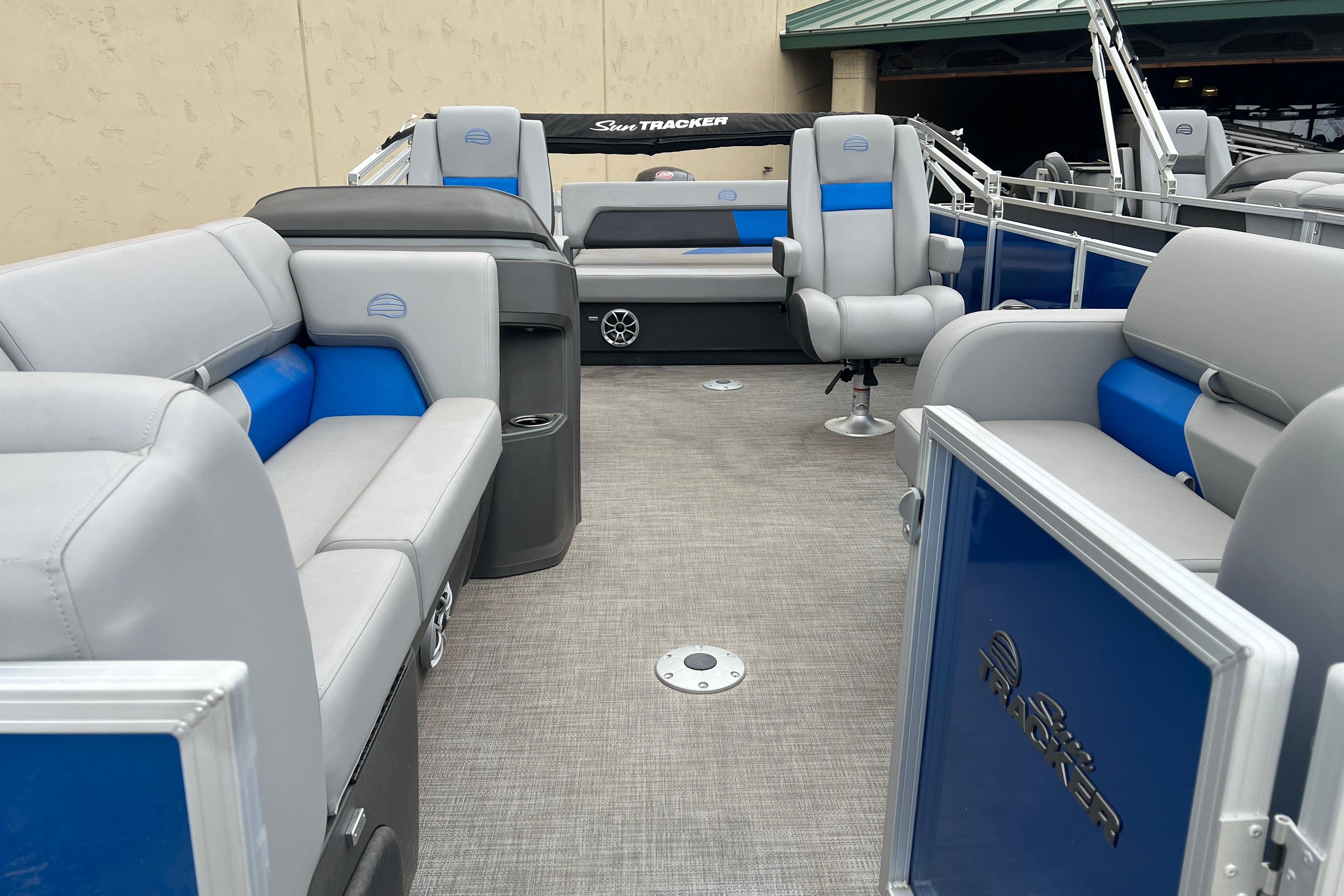 2026 Sun Tracker Party Barge 22 RF DLX interior with gray and blue seating.