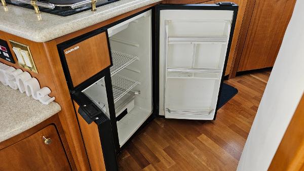 Open refrigerator in 2000 Carver 450 Voyager Pilothouse yacht kitchen interior.
