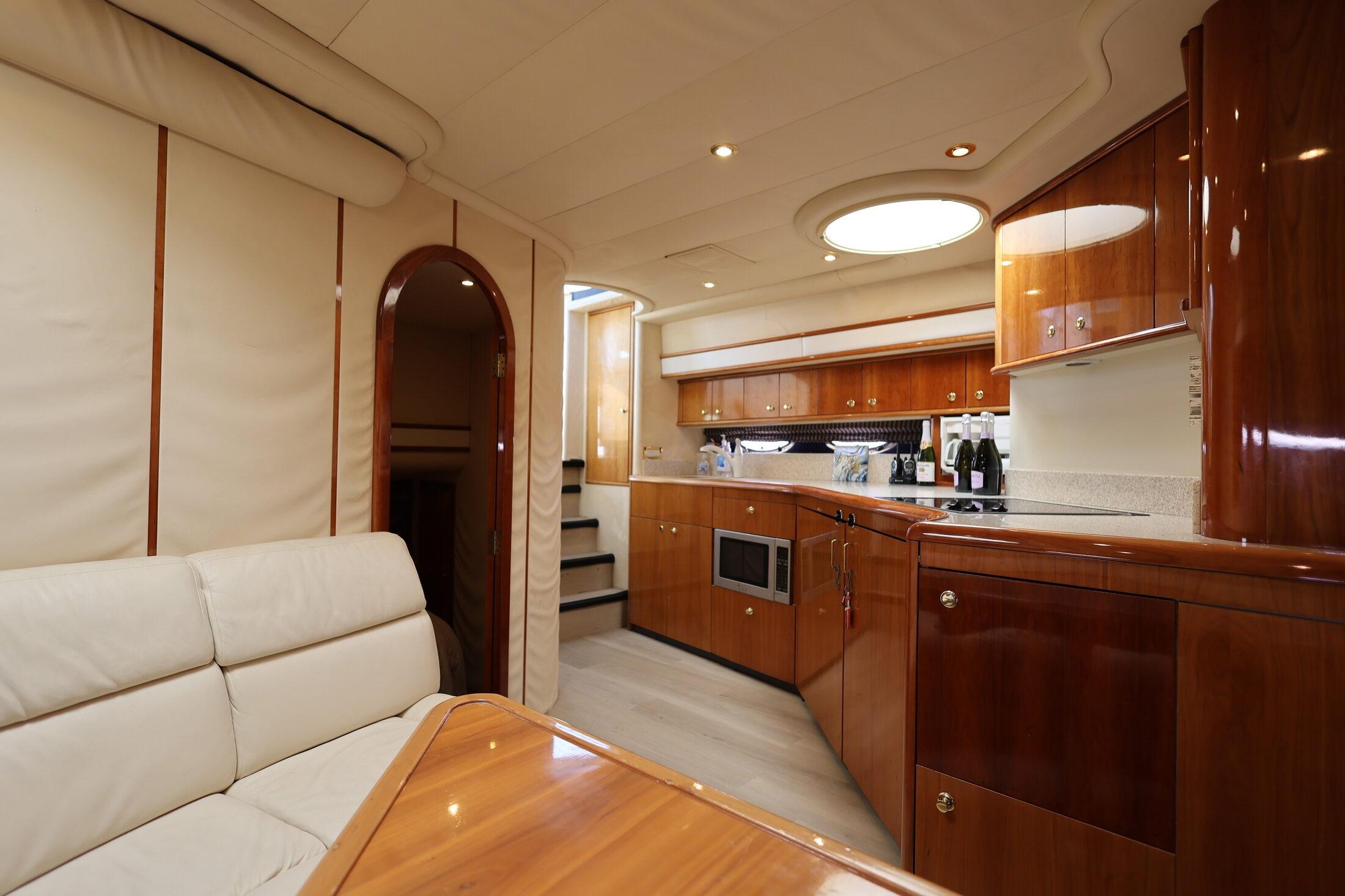 Luxurious interior of 1999 Neptunus 54 Express yacht with elegant wood finishes.