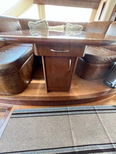 Luxurious wooden dining area in a 2009 Ovation 52 yacht.