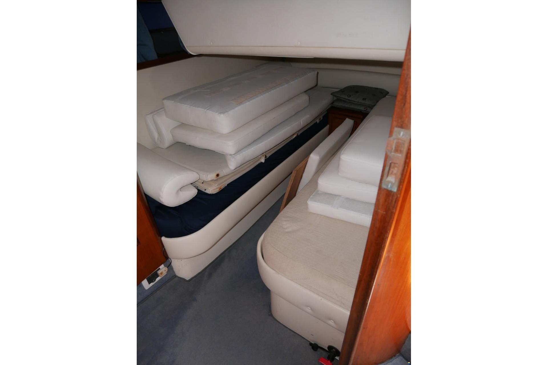 Interior cabin of 1994 Fairline Phantom 37 with stacked cushions.