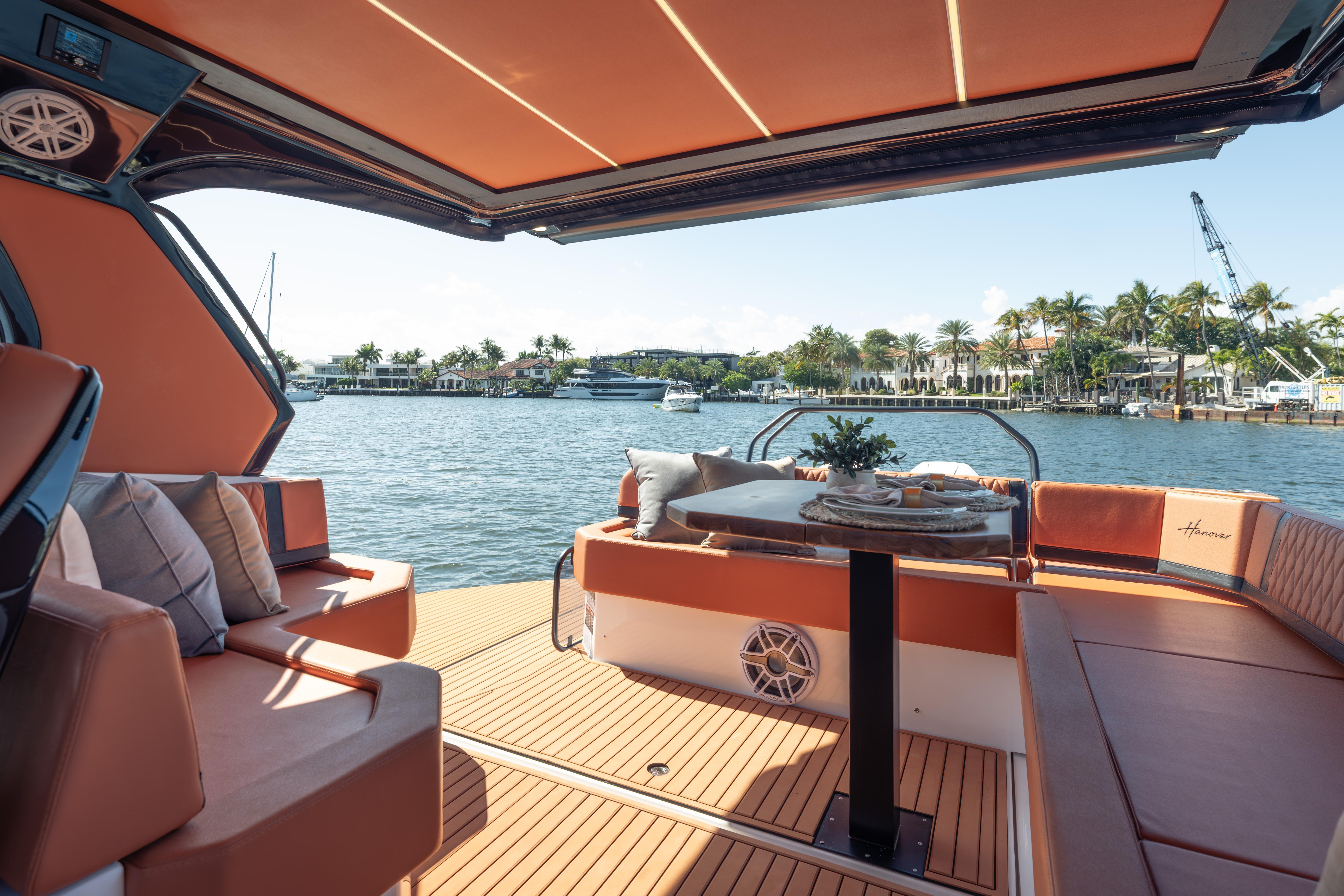Luxurious Hanover 387 yacht interior with elegant seating, table, and waterfront view, 2026 model.