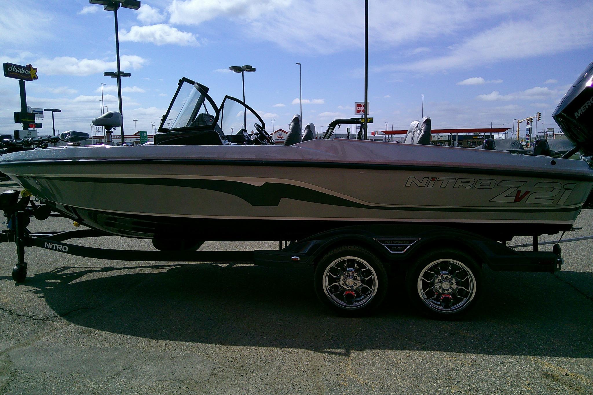 2026 Nitro ZV21 Pro boat on trailer in parking lot under clear sky.