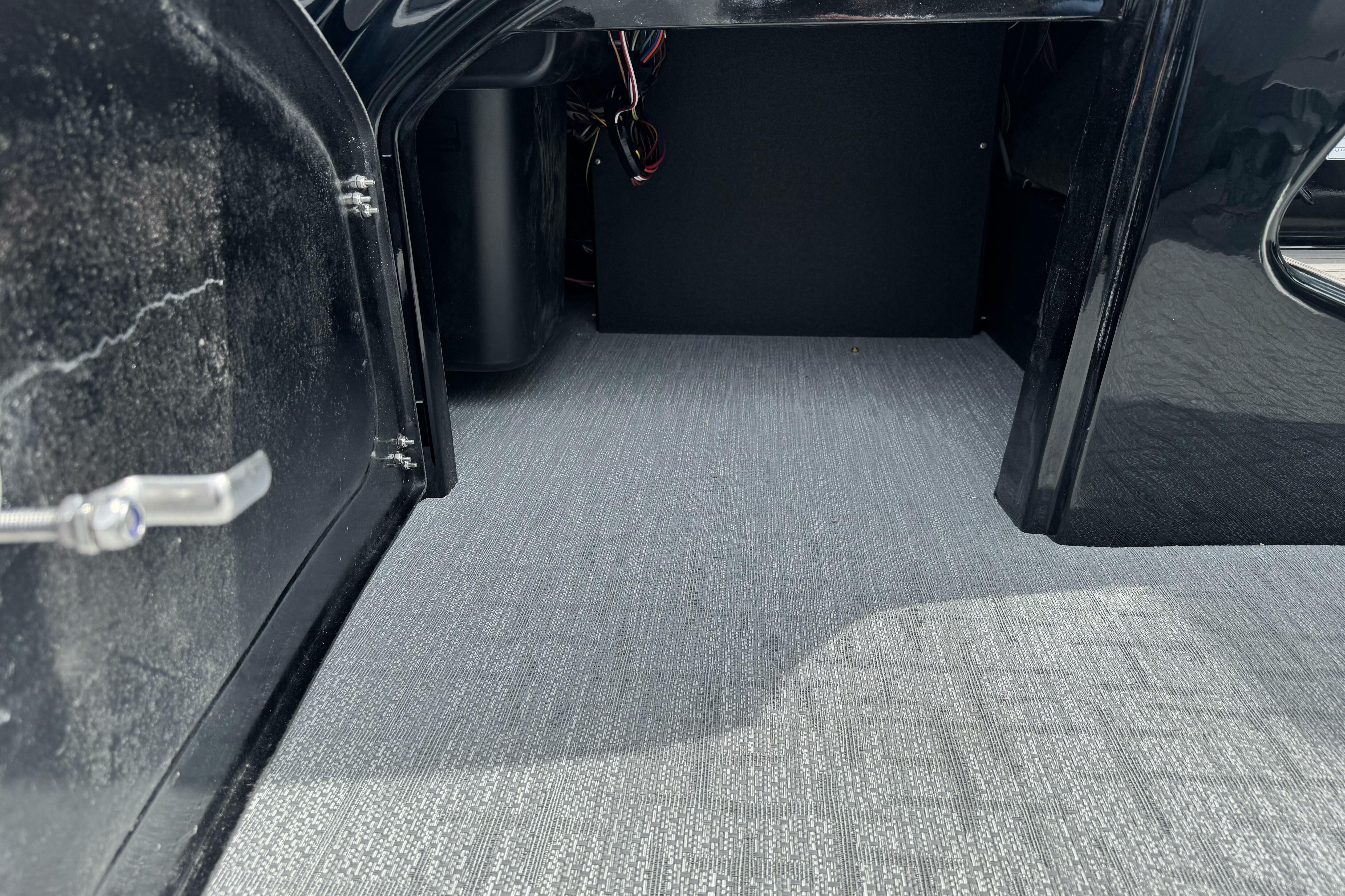 Open storage compartment of 2026 Regency 250 DL boat, featuring clean interior space.