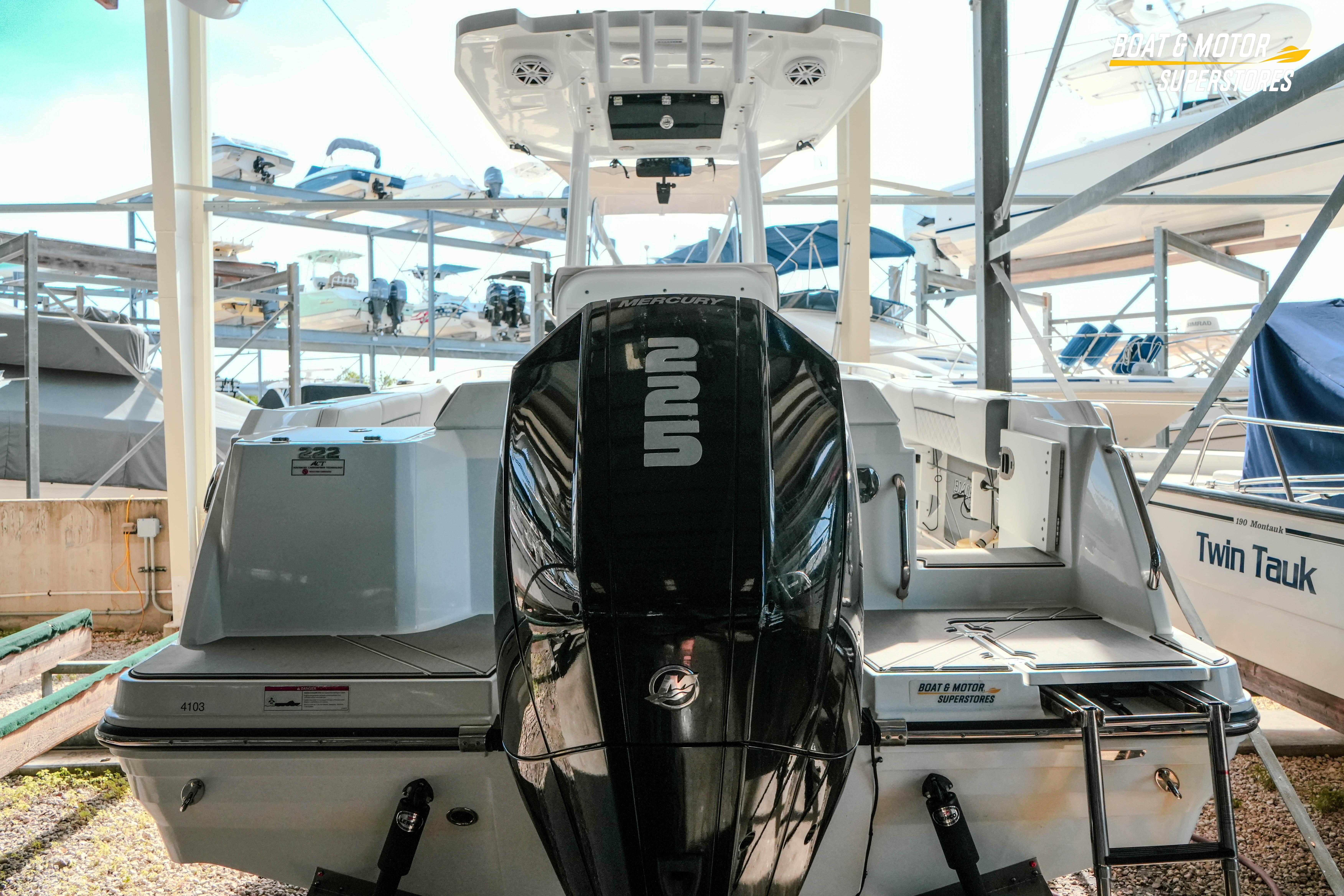 2022 Blackfin 222 CC boat with Mercury engine in a marina storage area.