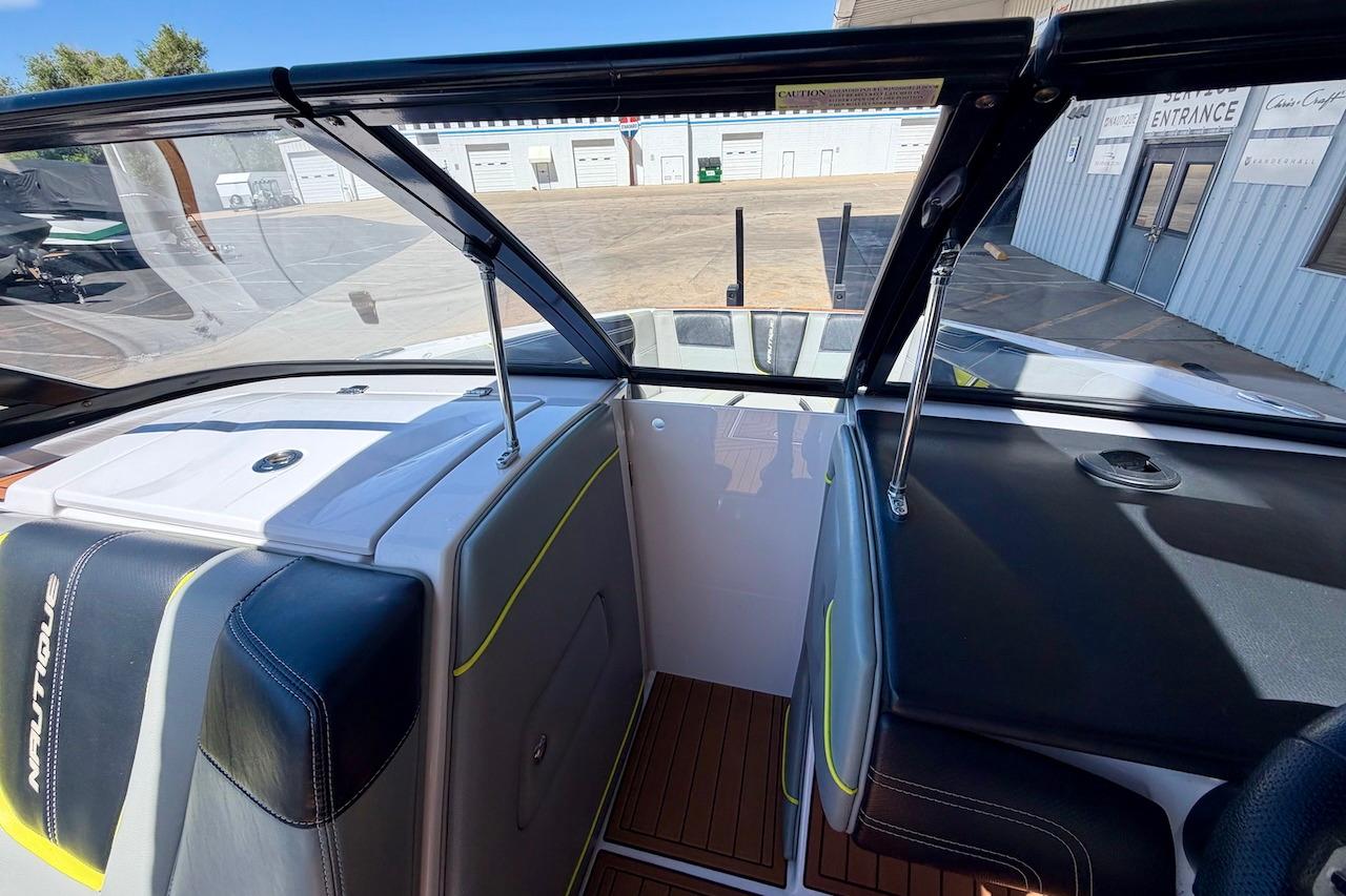 Interior view of 2014 Nautique Super Air Nautique G21 boat, showcasing seating and dashboard.