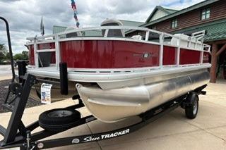 2026 Sun Tracker Bass Buggy 18 DLX pontoon boat on trailer, red and silver design.