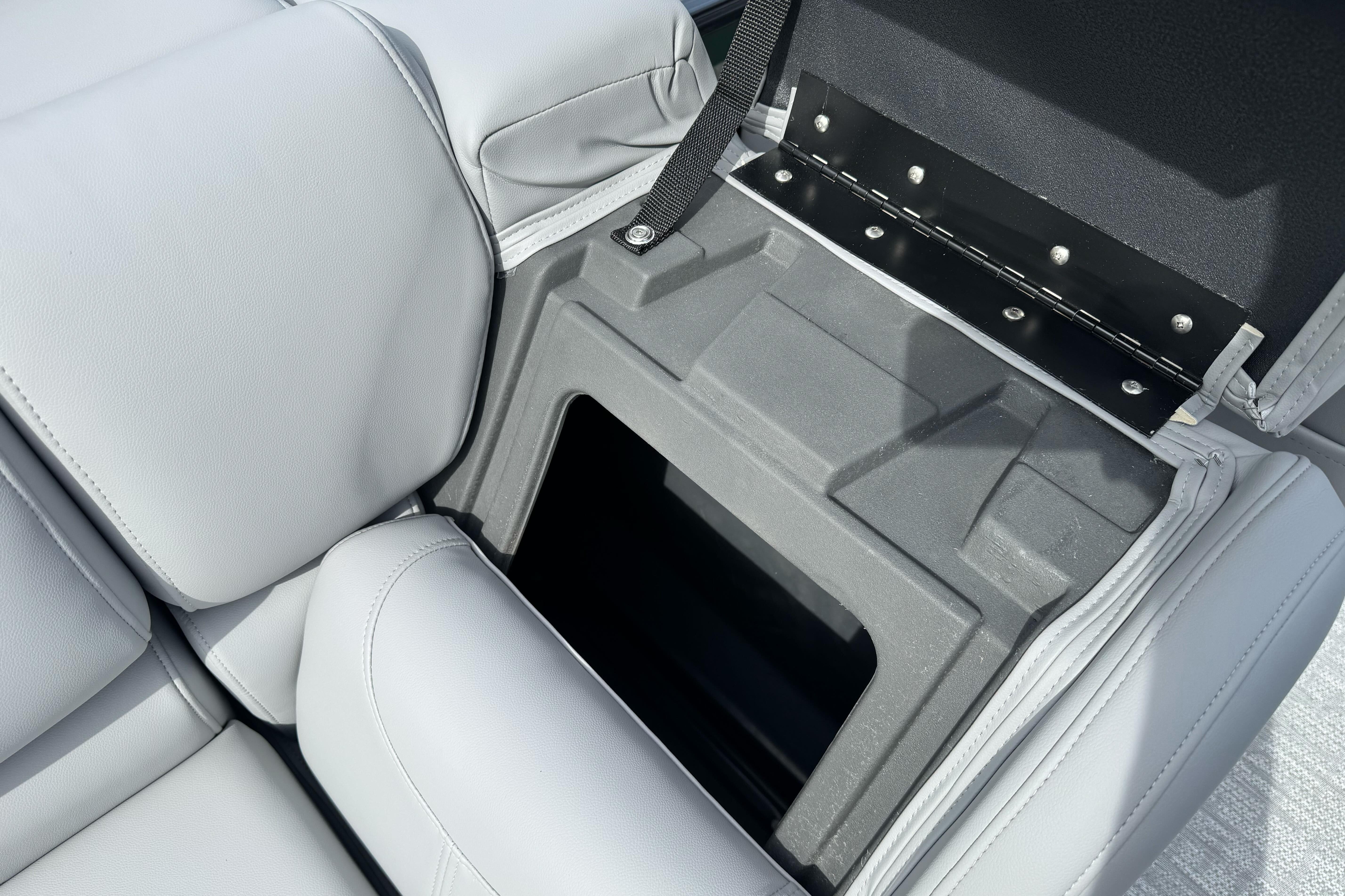 Open storage compartment in 2026 Regency 250 DL boat seat.