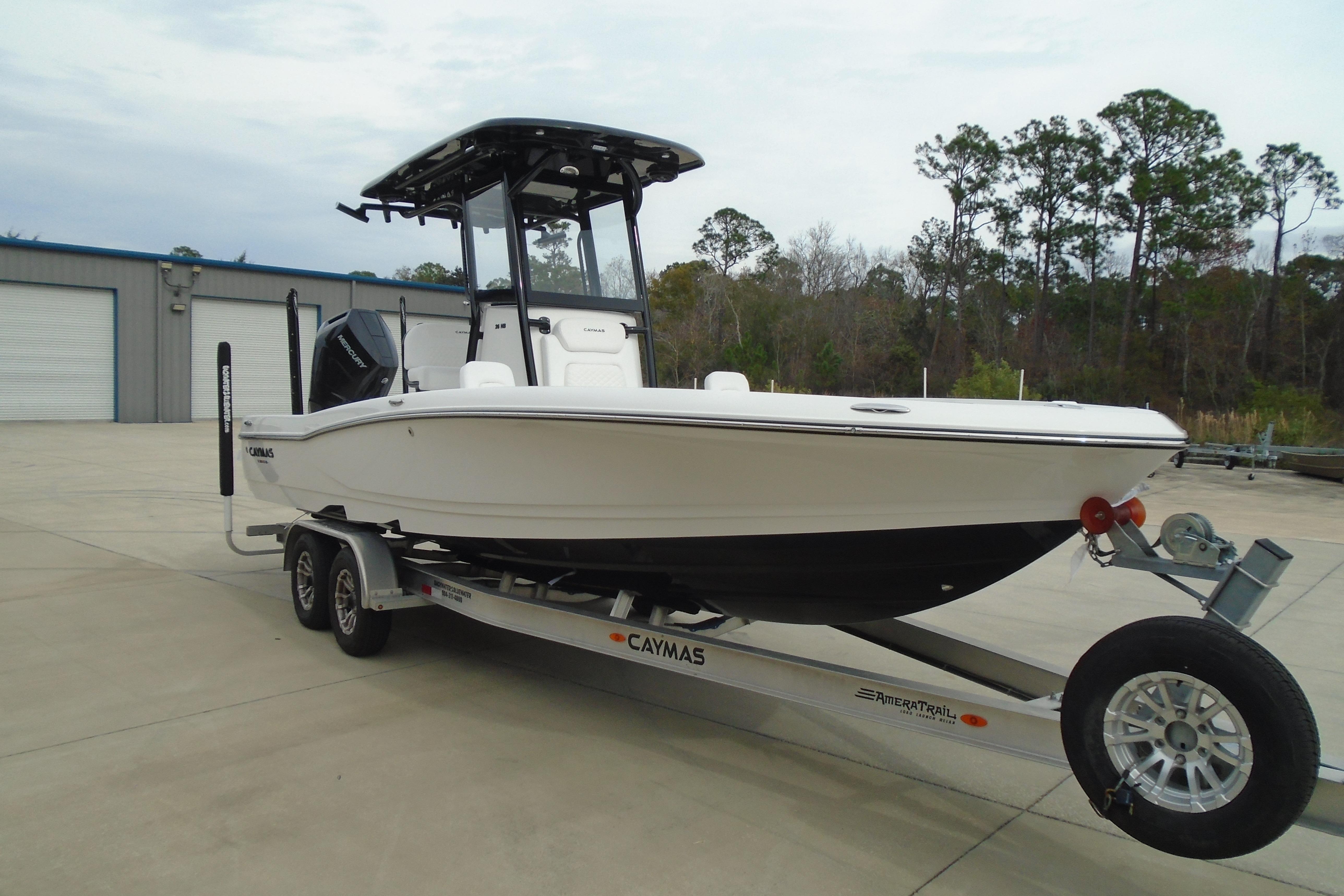 2026 Caymas 26 HB boat on trailer, parked outdoors near a building.