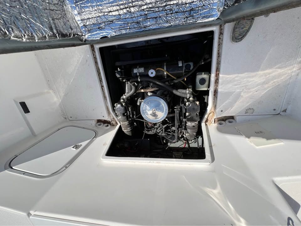 Engine compartment of a 1999 Bayliner 2452 boat, open for maintenance.