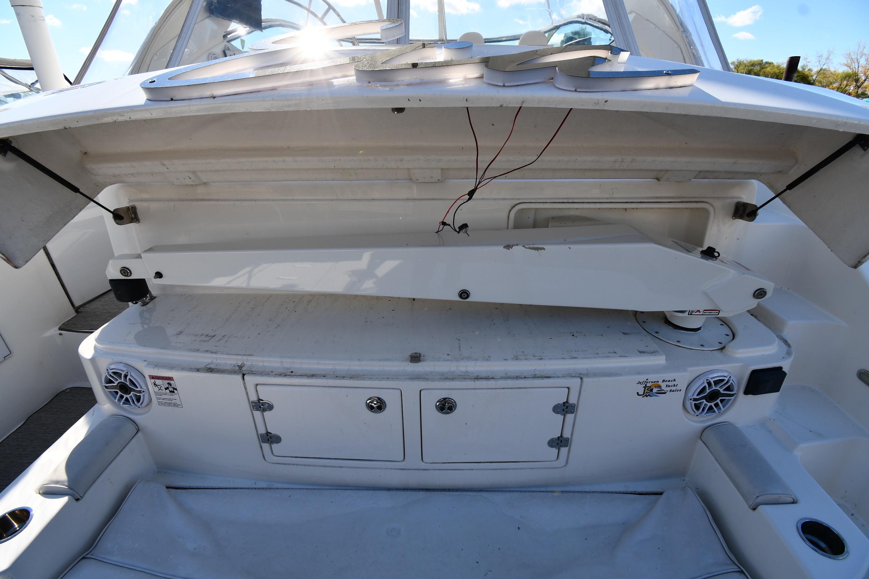 2005 Cruisers Yachts 500 Express interior with open storage compartment and speakers.