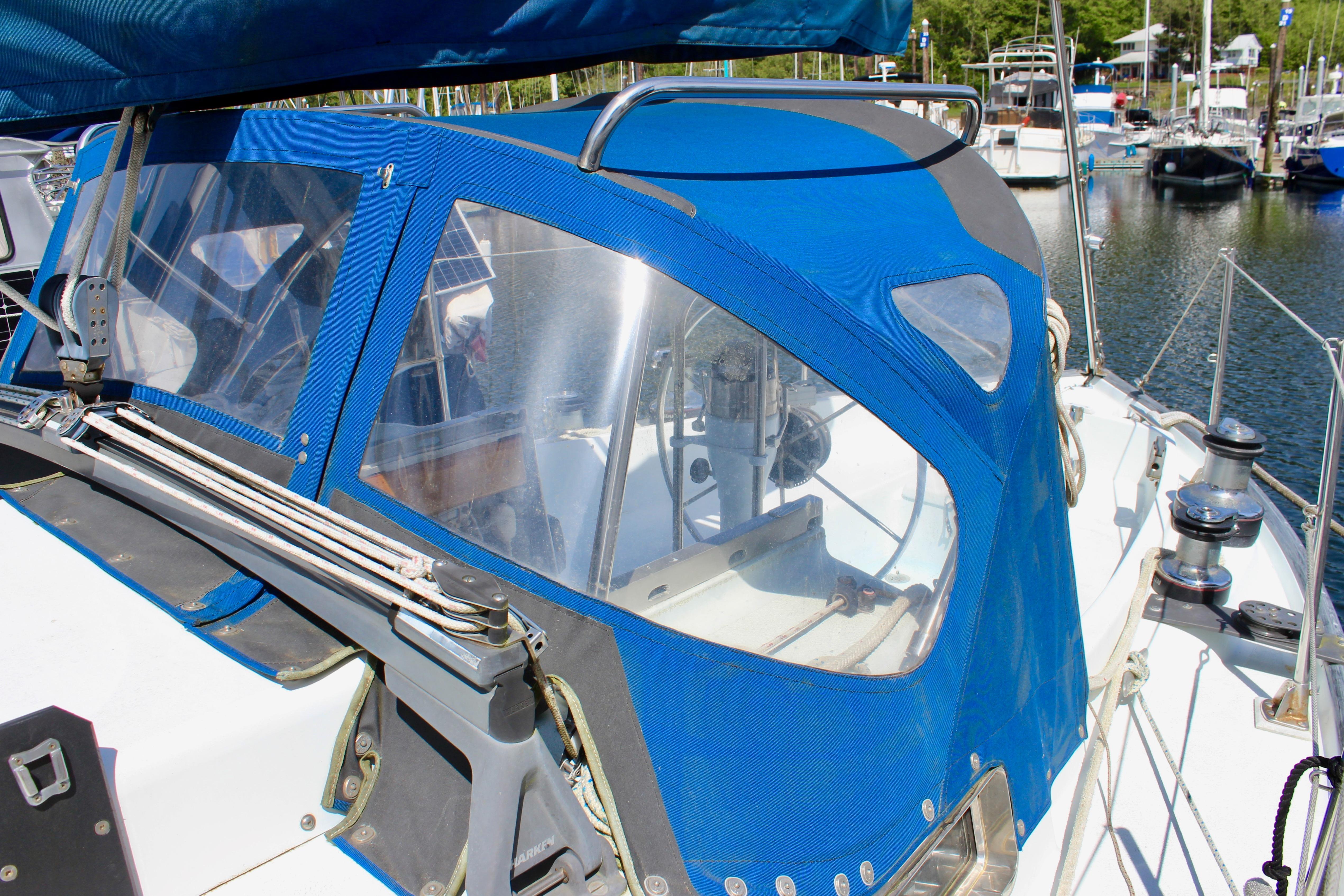 Sailboat cockpit with blue canopy, Freya 39 model, 1993, docked in marina.