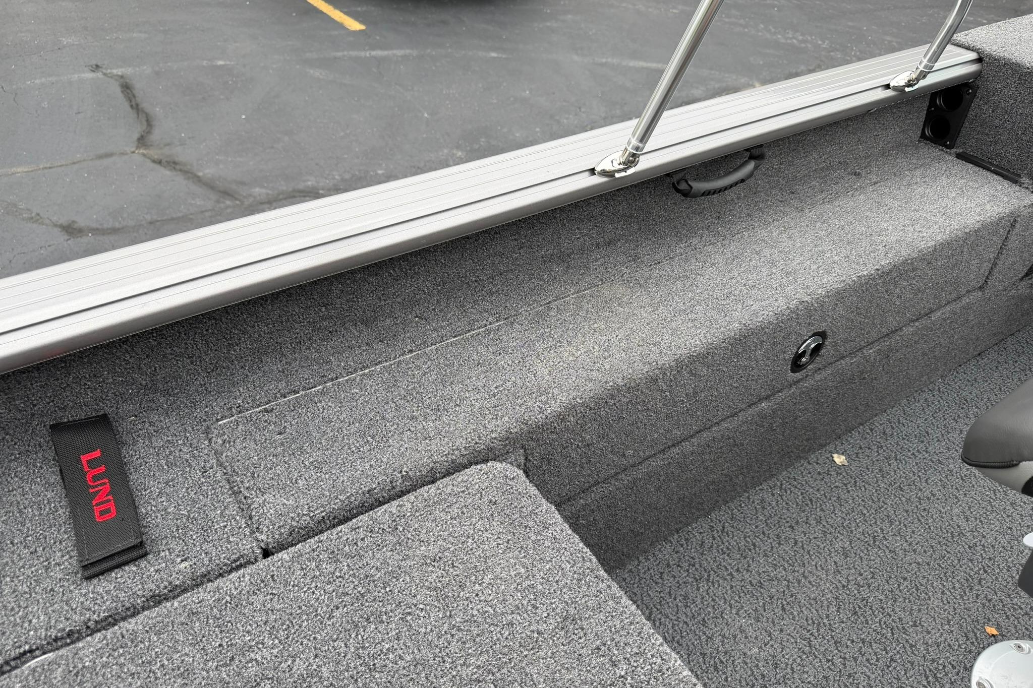 Interior view of 2027 Lund 2075 Impact XS boat with gray carpeted seating.