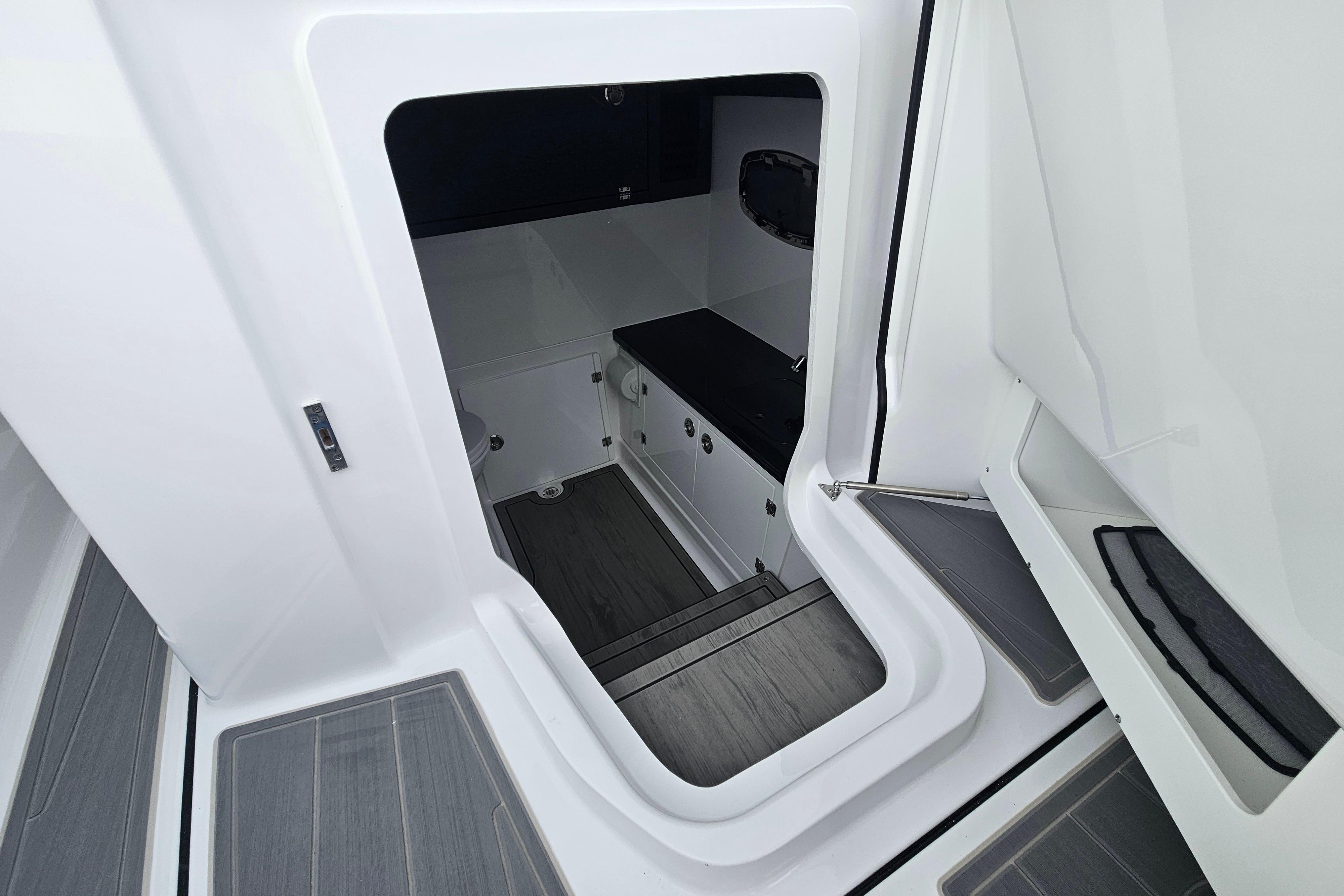 Interior cabin view of 2026 Monterey Elite 27 OB boat, featuring sleek design and modern amenities.