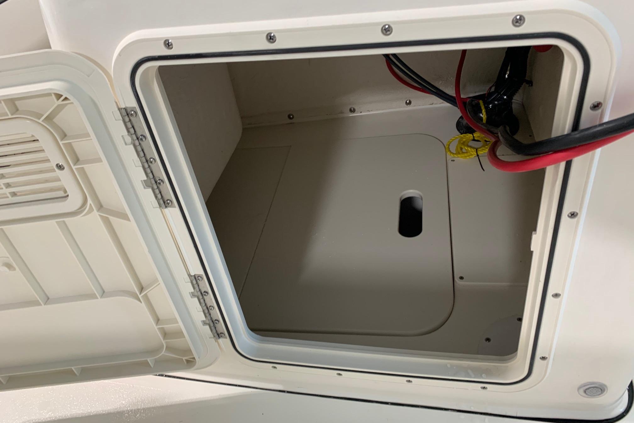 Open storage compartment on 2026 Key West 188 Bay Reef boat, showing interior wiring.
