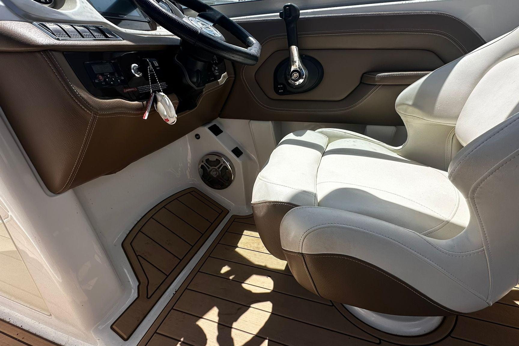 2015 Chaparral 264 Sunesta boat interior with steering wheel and captain's seat.