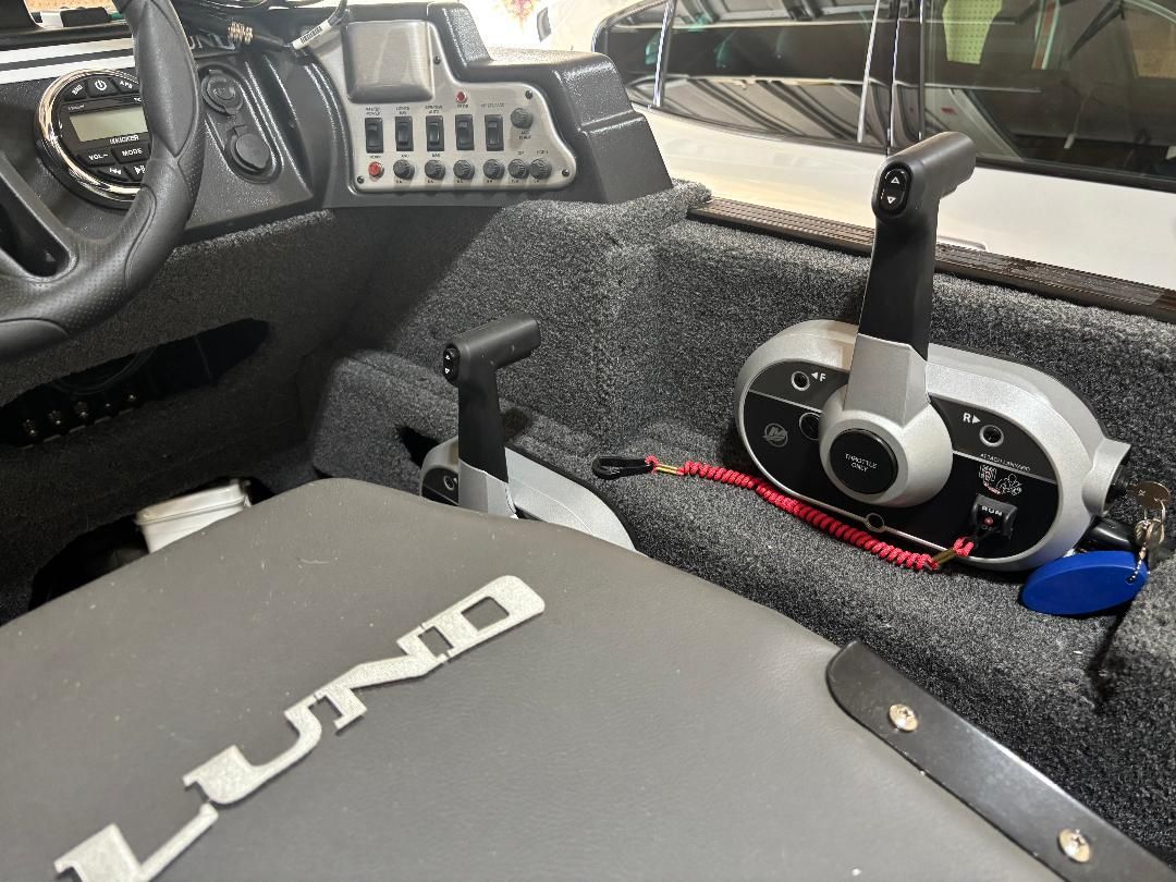 Interior view of a Lund boat with controls and instruments.
