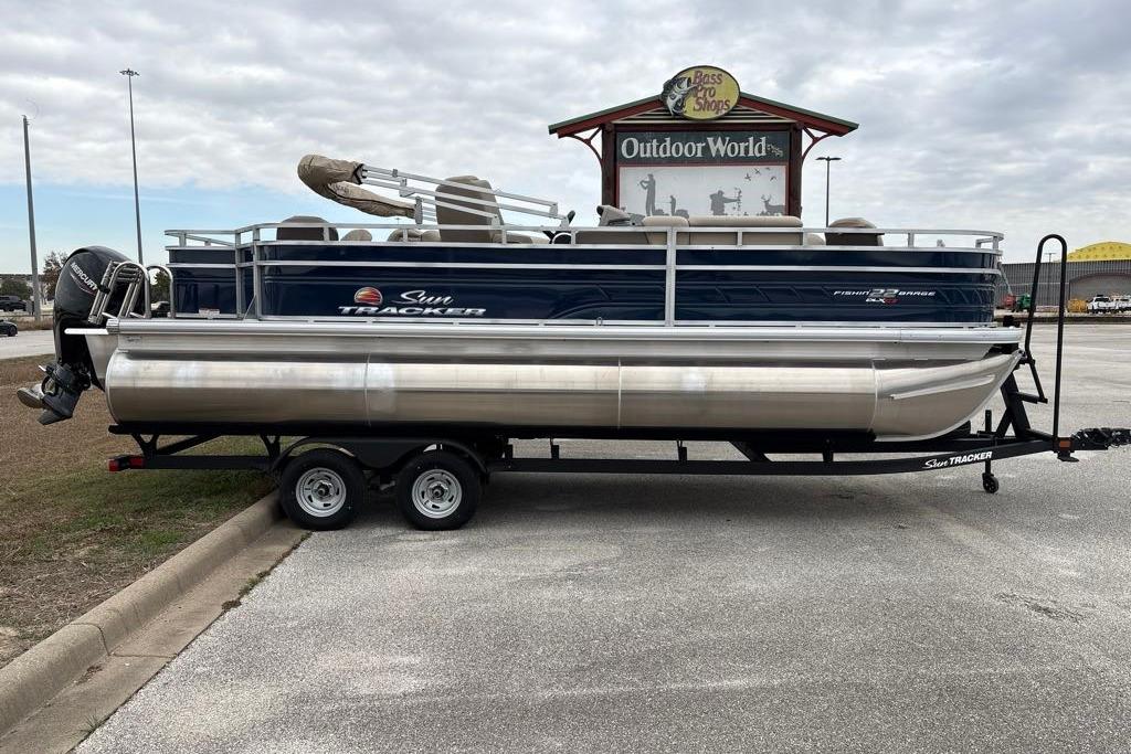 2025 Sun Tracker Fishin' Barge 22 XP3 pontoon boat on trailer at Outdoor World.