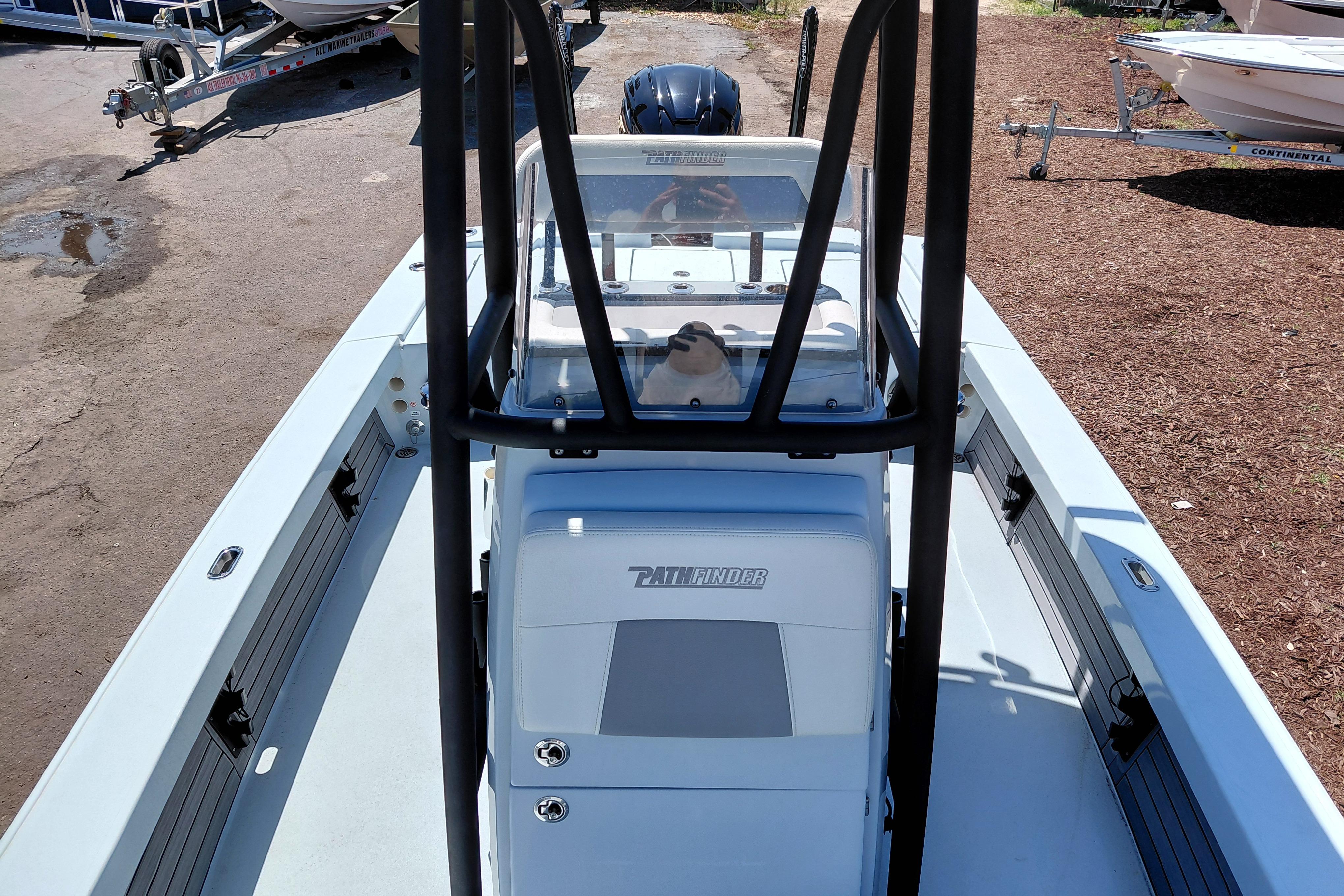 2022 Pathfinder 2300 HPS boat interior with console and seating, parked on a trailer.